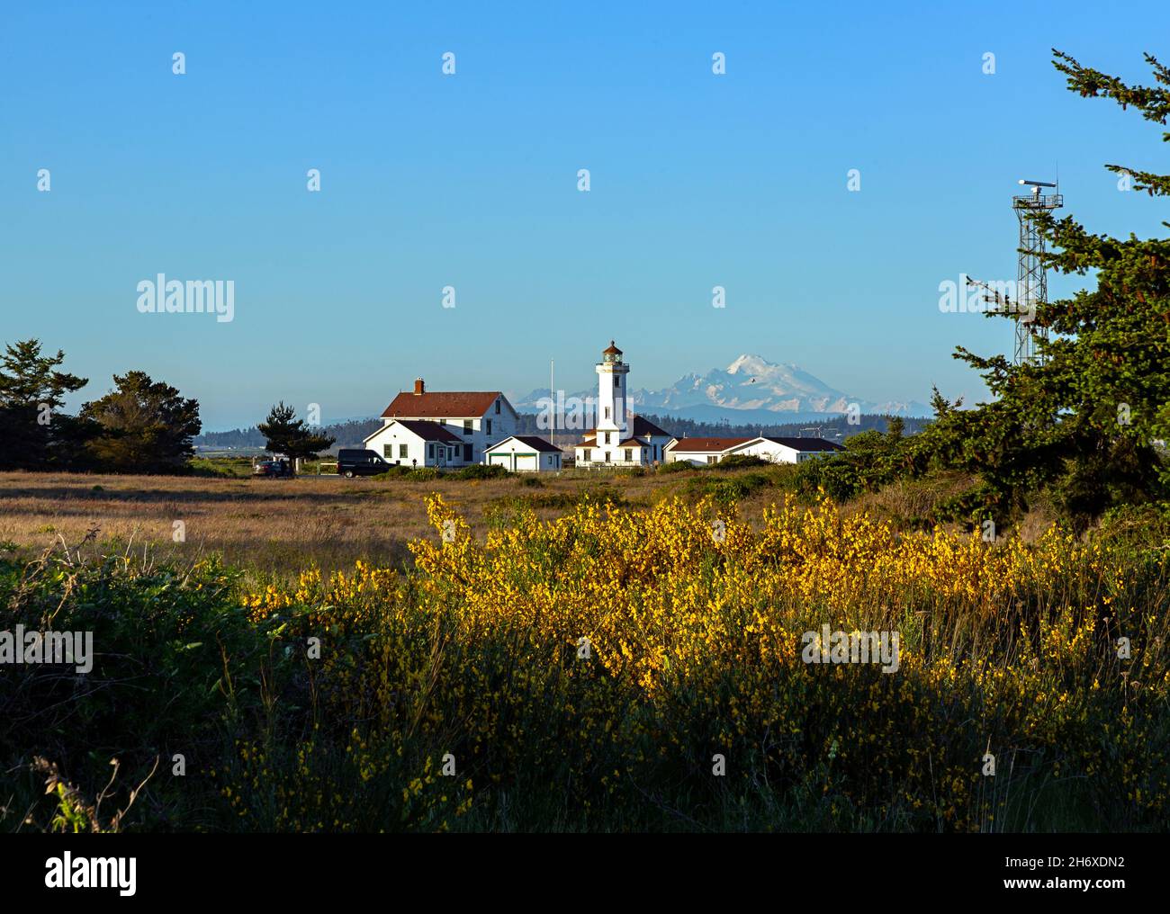 WA19793-00...WASHINGTON - Point Wilson Lighthouse and Mount Baker viewed at sunset from Fort Worden State Park. Stock Photo