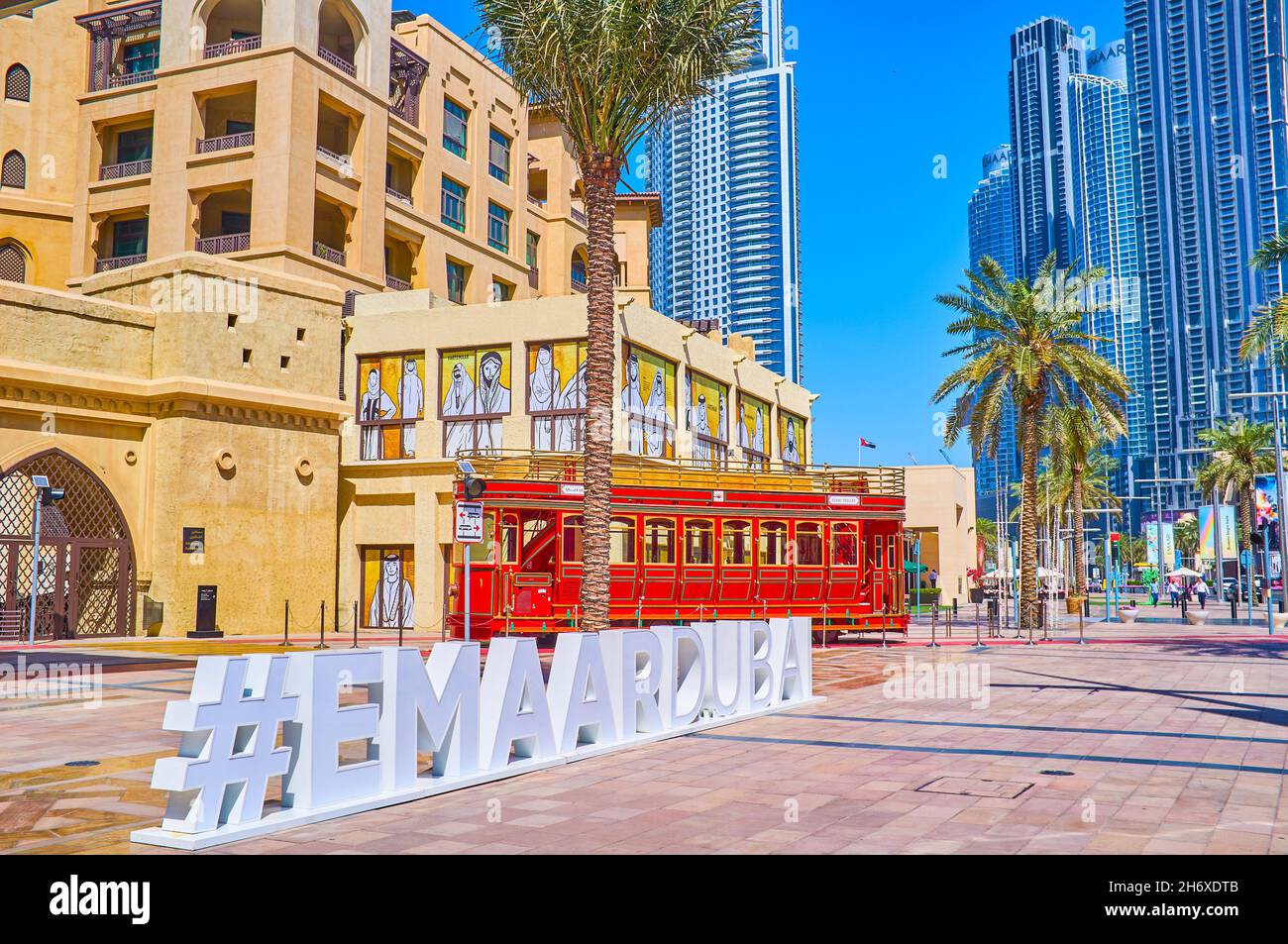 DUBAI, UAE - MARCH 3, 2020: The vintage styled Dubai Trolley city tram and the sign EmaarDubai in Sheikh Mohammed bin Rashid Boulevard in Downtown, on Stock Photo