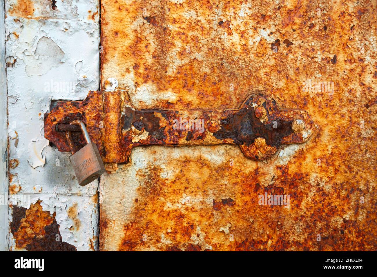WA19798-00...WASHINGTON - Rust covered door and latch on a storage shed at Point Wilson Lighthouse in Fort Worden State Park. Stock Photo