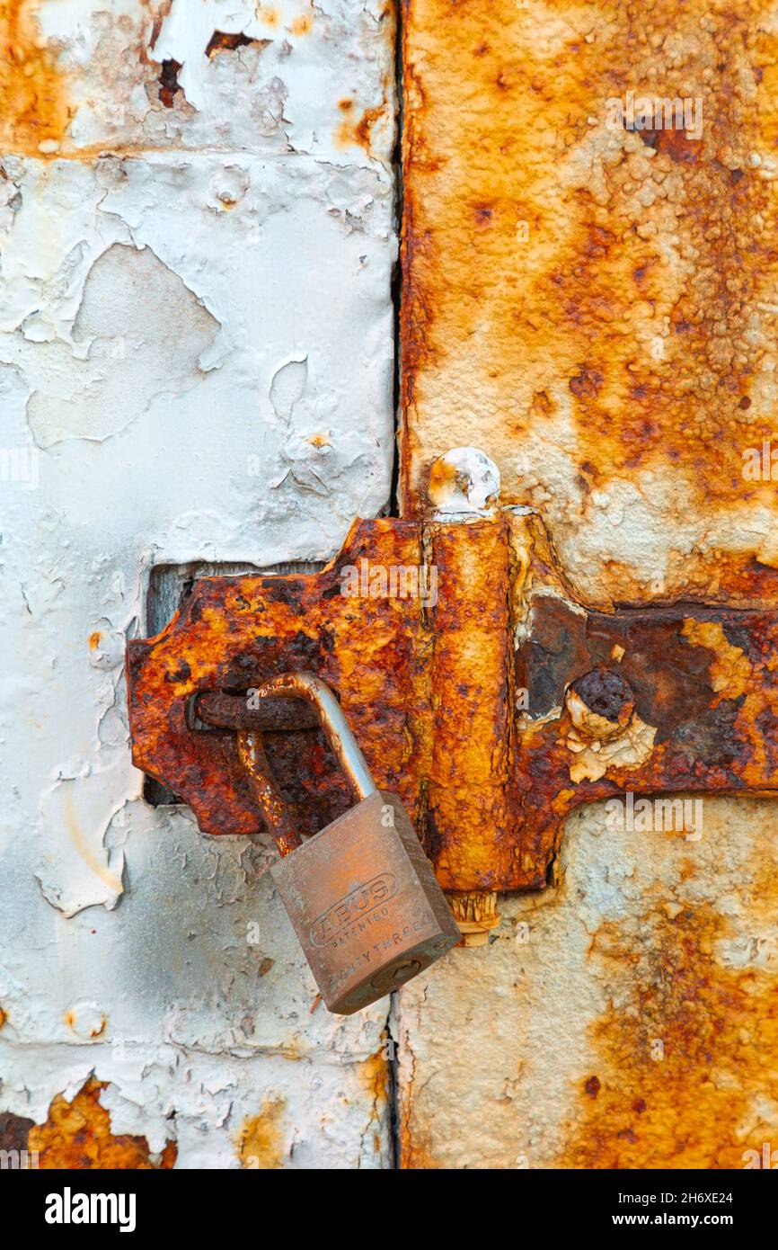 WA19799-00...WASHINGTON - Rust covered door and latch on a storage shed at Point Wilson Lighthouse in Fort Worden State Park. Stock Photo