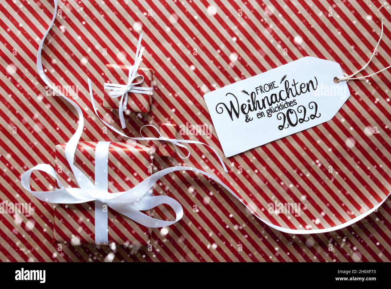 Three Gifts, Wrapping Paper, Label Glueckliches 2022 Mean Happy 2022, Snowflakes Stock Photo