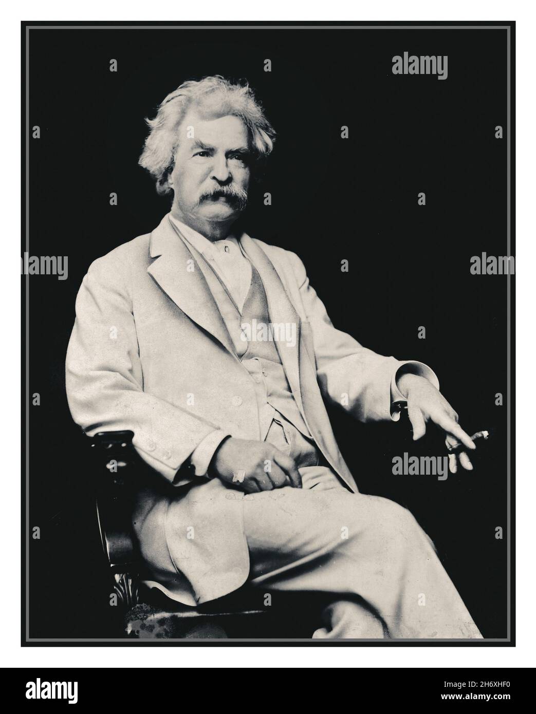 MARK TWAIN Vintage 1900s Archive portrait of Mark Twain, three-quarter length portrait, seated, facing slightly right, with cigar in hand] Date Created/Published: c1907.1 photographic archive print. Stock Photo