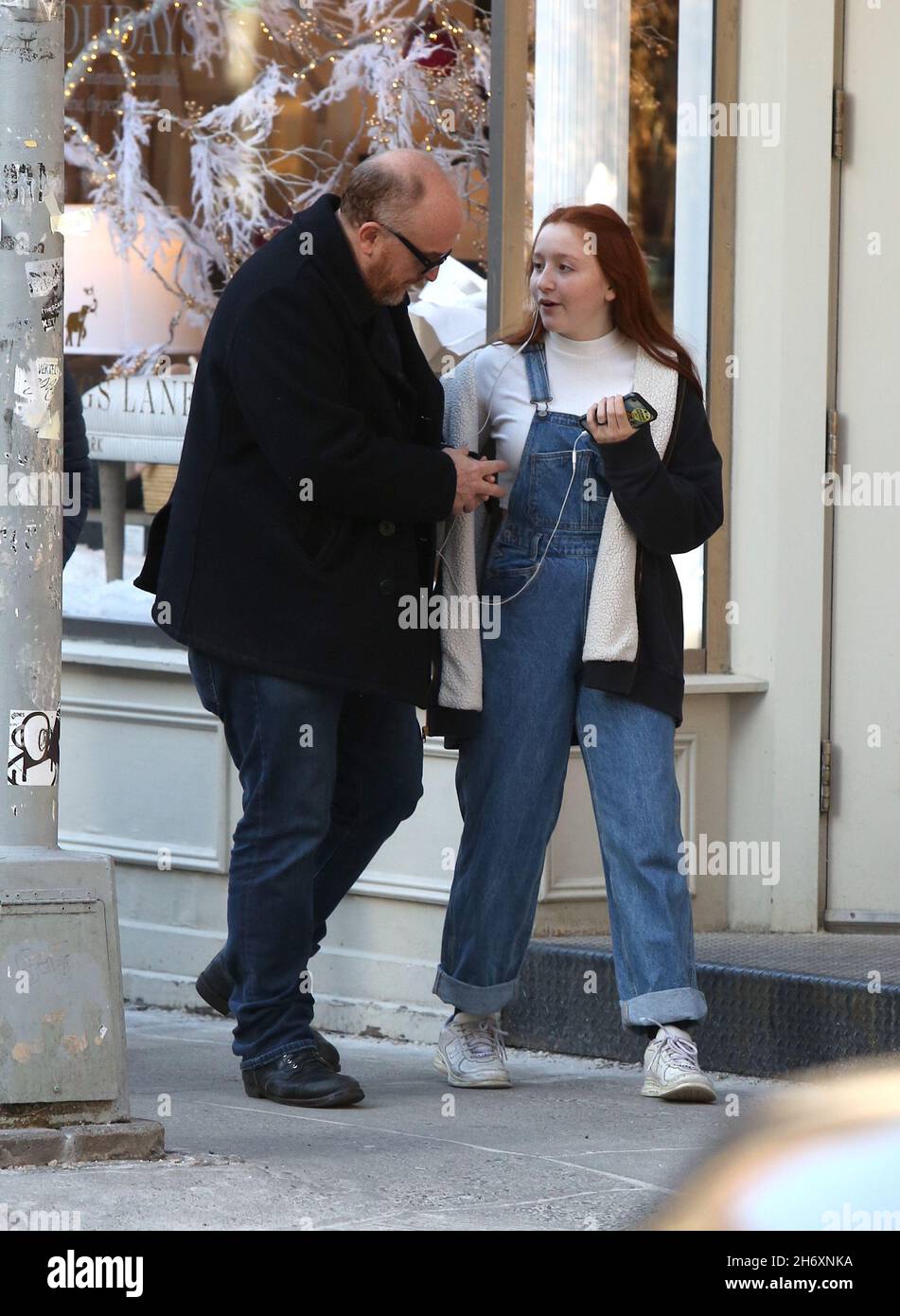 New York - NY - 12/23/2019- Louis C.K. and daughter Mary Louise Szekely (14  years old) joking around with each other and sharing headphones in Soho  -PICTURED: Louis C.K.Mary Louise Szekely Stock Photo - Alamy