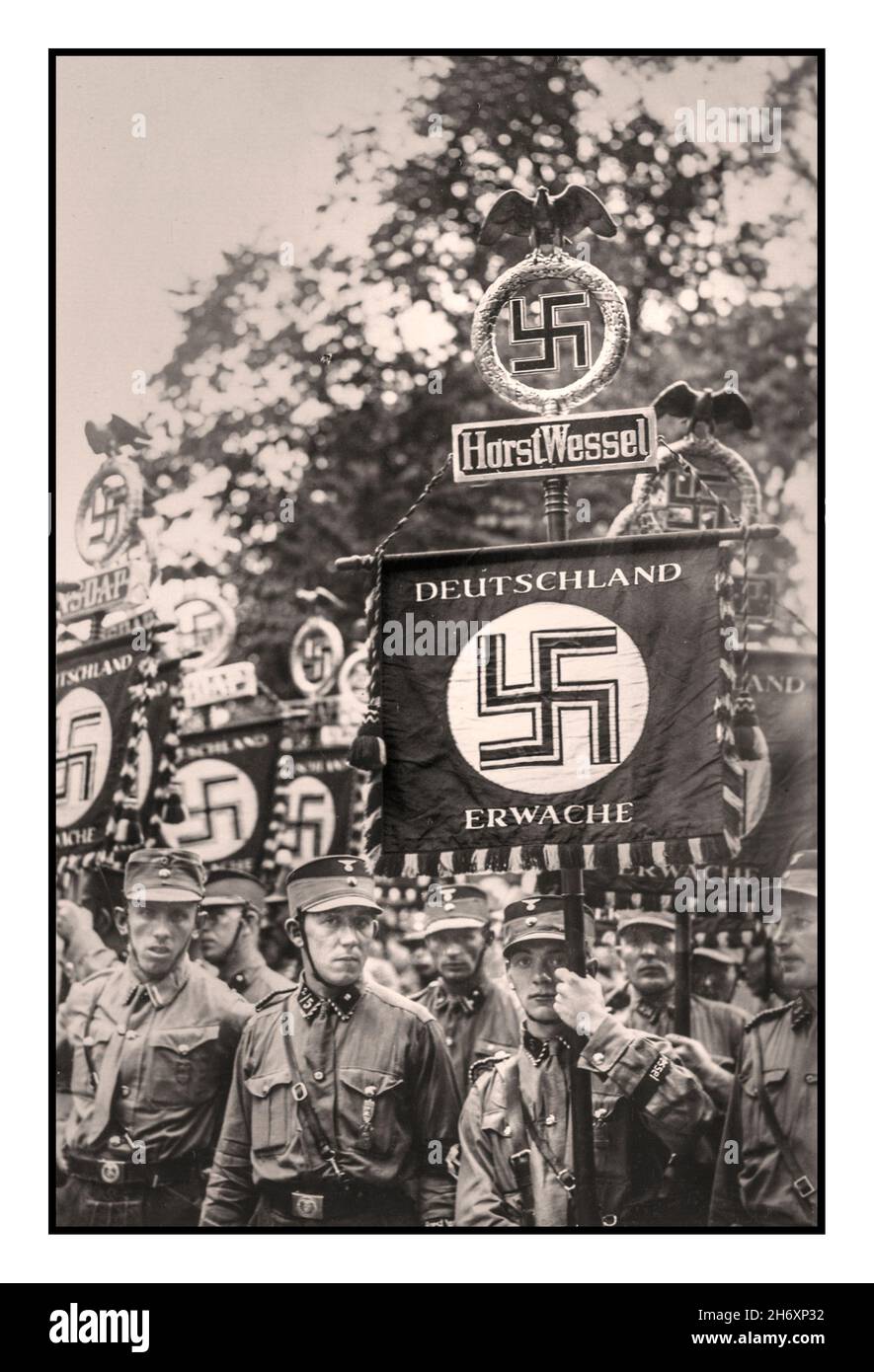 1933 Nazi Germany Reichsparteitag 1930s Nurnberg Rally with Die Horst Wessel Standarte DEUTSCHLAND ERWACHE 'Germany Awakes'  Horst Ludwig Georg Erich Wessel (9 October 1907 – 23 February 1930) was a Berlin Sturmführer ('Assault Leader', the lowest commissioned officer rank) of the Sturmabteilung (SA), the Nazi Party's stormtroopers. After his murder in 1930, he was made into a martyr and hero for the Nazi cause by Propaganda Minister Joseph Goebbels. Stock Photo
