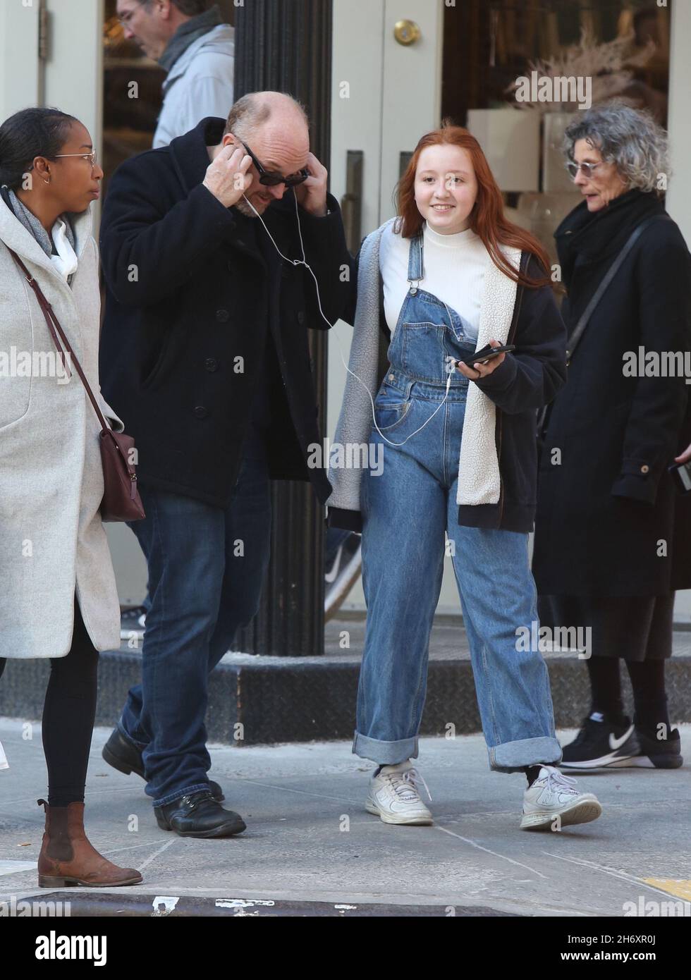New York - NY - 12/23/2019- Louis C.K. and daughter Mary Louise Szekely (14  years old) joking around with each other and sharing headphones in Soho  -PICTURED: Louis C.K.Mary Louise Szekely Stock Photo - Alamy
