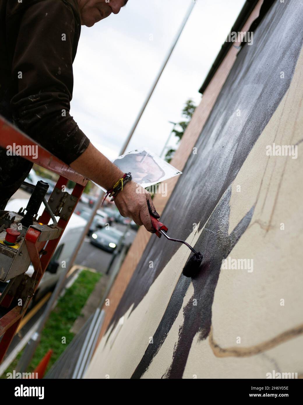 Andy 'Dice' Davies painting a Mural of Killing Joke's Jaz Coleman as a surprise for him at High Street Car Park. Stock Photo