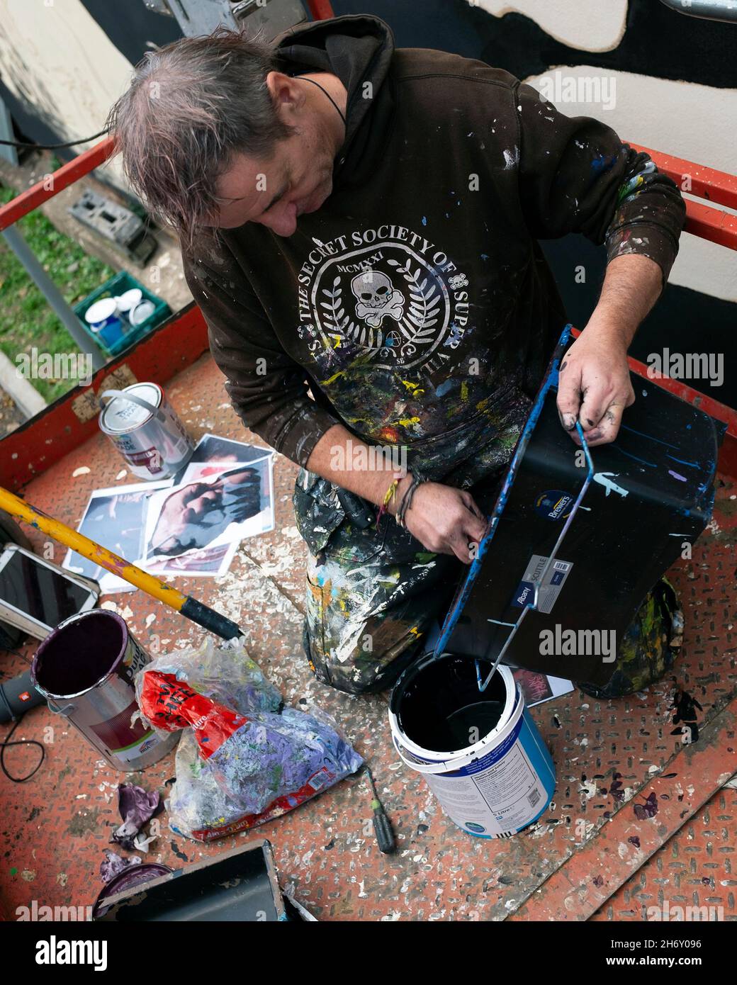 Andy 'Dice' Davies painting a Mural of Killing Joke's Jaz Coleman as a surprise for him at High Street Car Park. Stock Photo