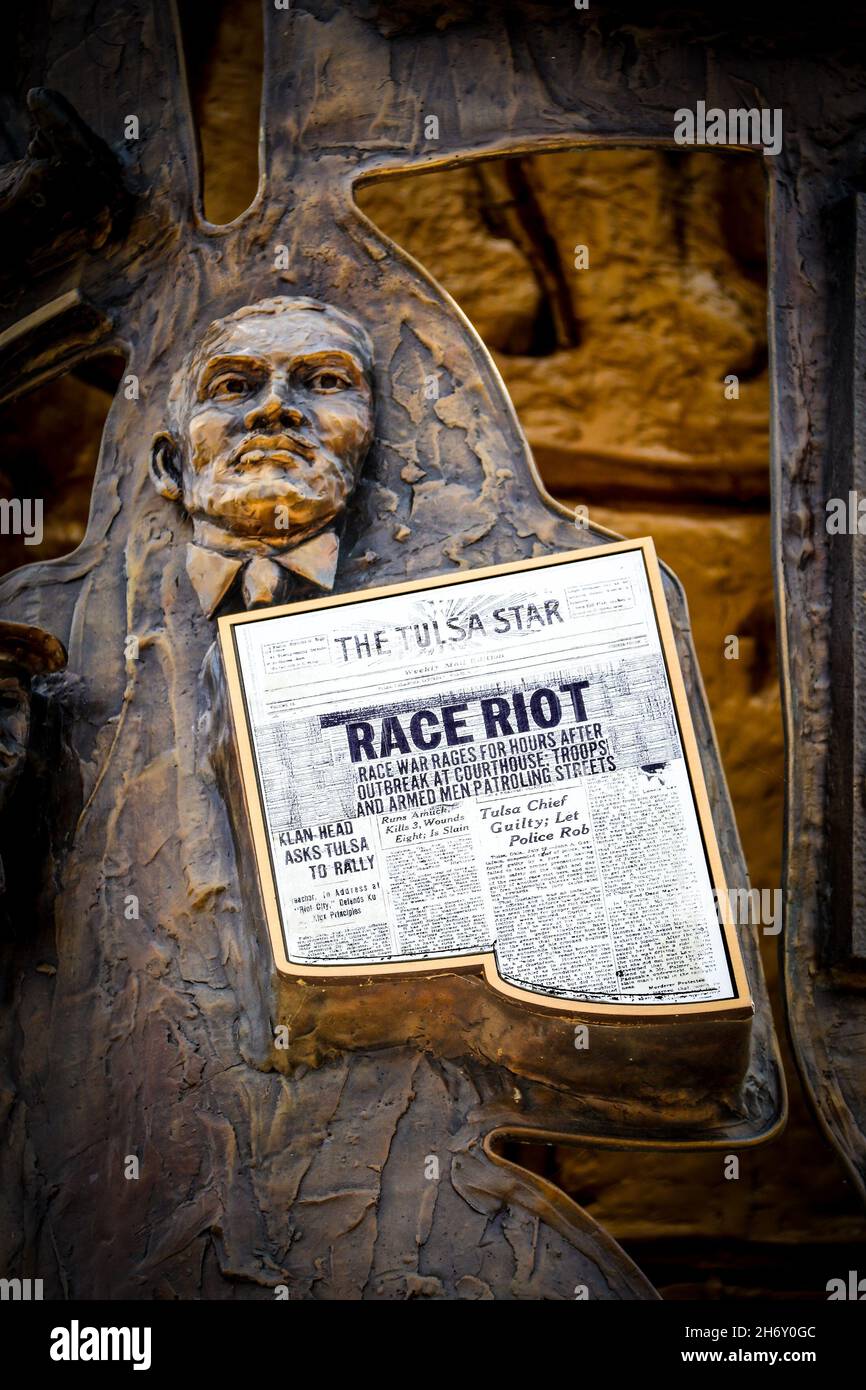 07 2- 2021 Tulsa USA Man holds newspaper - Tulsa Star with headlines Race Riot - part of mural sculpture at Reconcilionation Park in Tulsa Oklahoma. Stock Photo