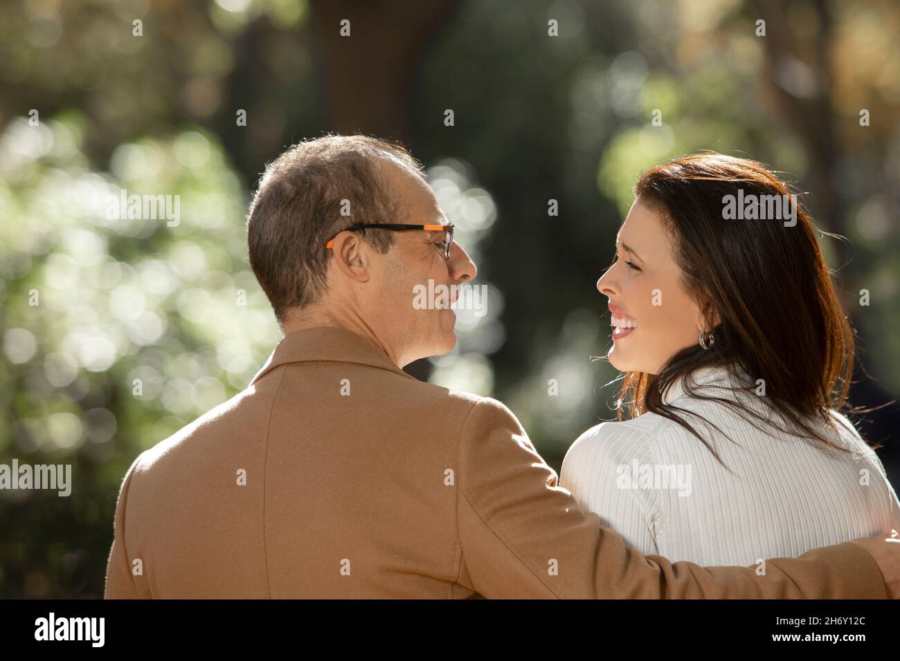 mature couple outdoors looking at each other with laughter Stock Photo