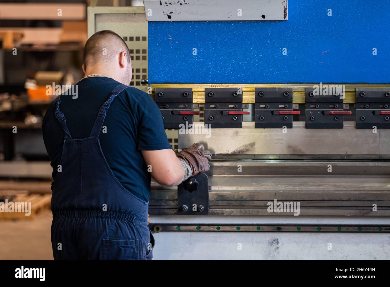 Workers work on sheet metal bending machines Stock Photo - Alamy