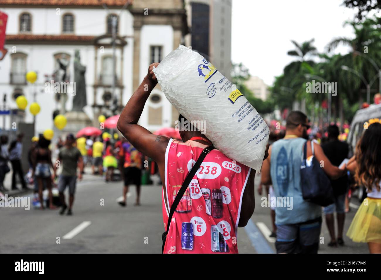 Brazil – February 22, 2020: A street vendor sells ice cubes for beverage cooling during a traditional Carnival street party in central Rio de Janeiro. Stock Photo