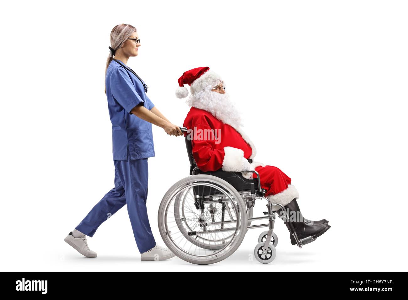 Santa Using A Walker Full length profile shot of a female nurse walking and pushing santa ...