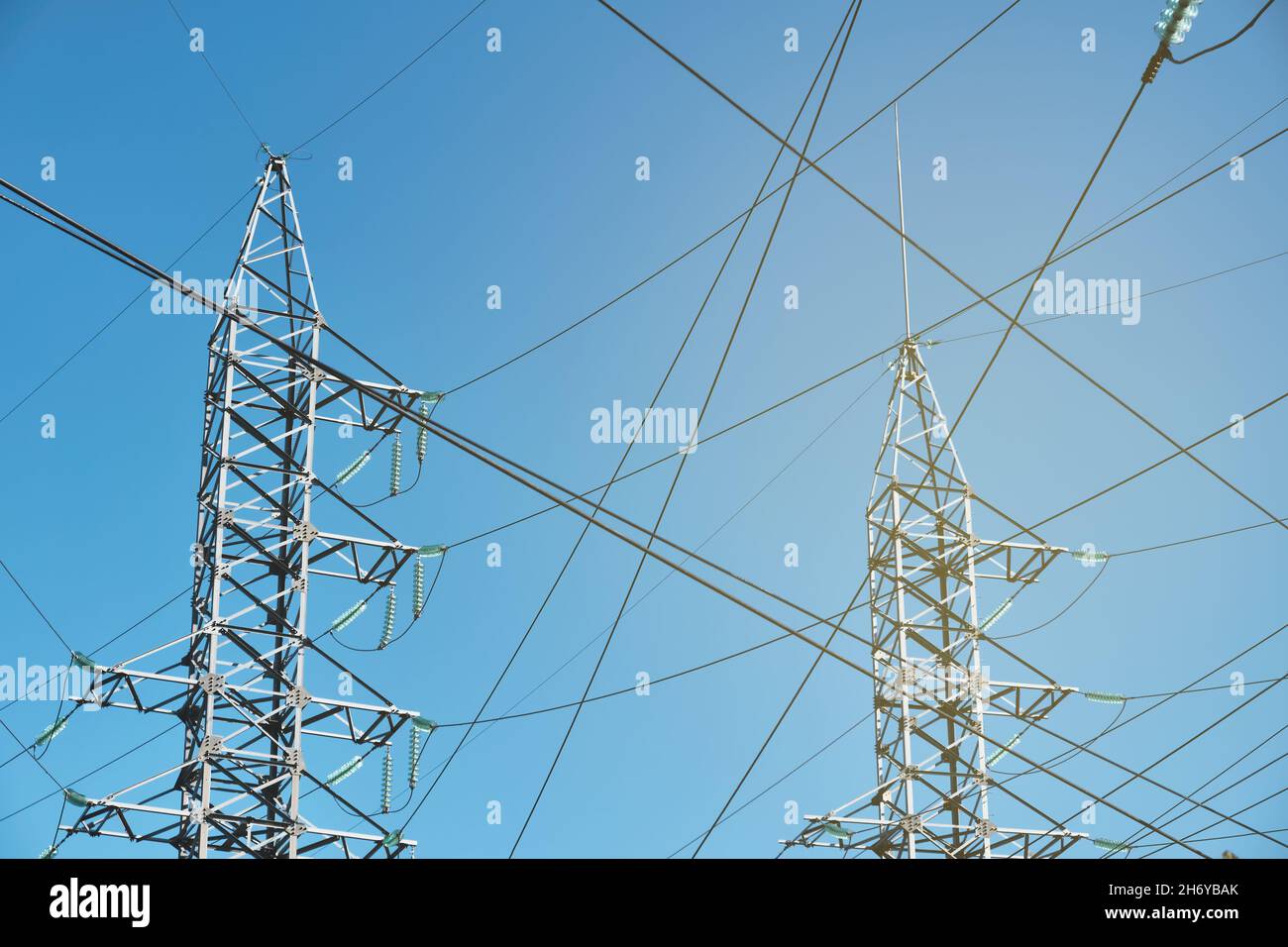 High-voltage power line against blue sky Stock Photo