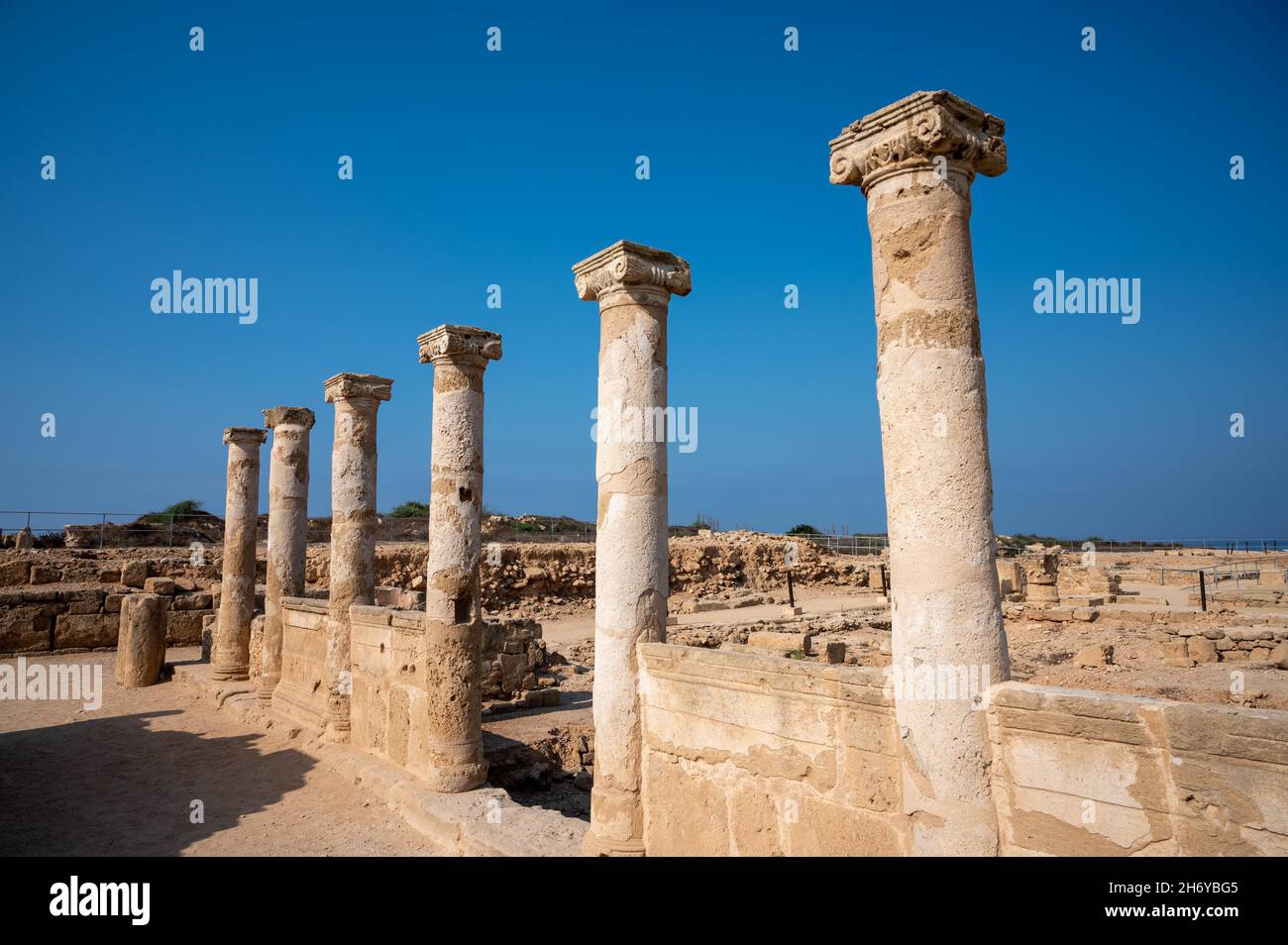 Columns and structures are part of the ancient romans ruins in Nea Paphos Archaeological Park - Cyprus Stock Photo