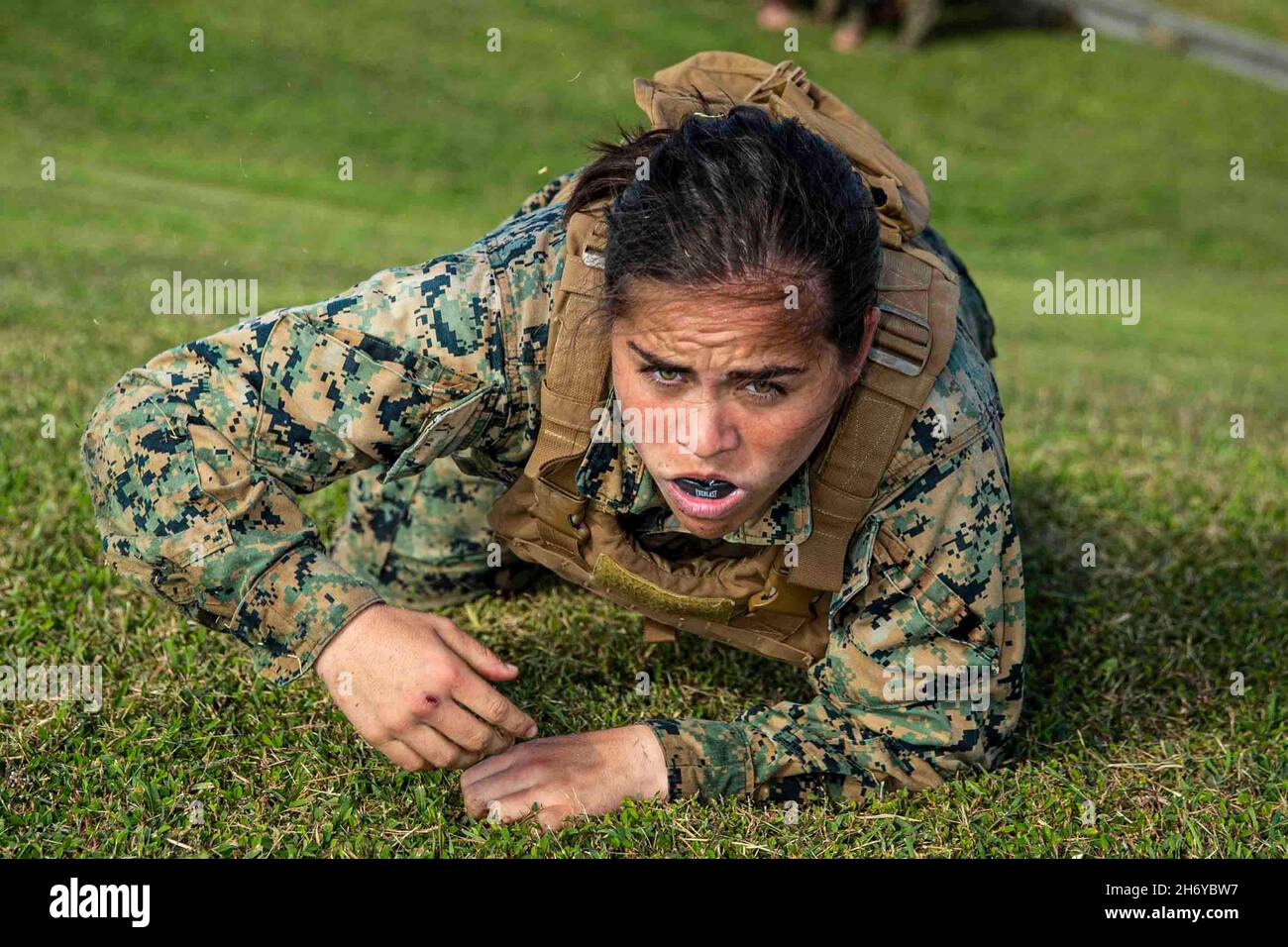 Japan. 4th Nov, 2021. U.S. Marine Cpl. Abigail Hermenegildo, an intelligence specialist with Battalion Landing Team 3/5, 31st Marine Expeditionary Unit (MEU), crawls up a hill during a Martial Arts Instructor Course culminating event at Camp Hansen, Okinawa, Japan, Nov. 4, 2021. The Martial Arts Instructor Course is designed to teach Marine Corps Martial Arts Program (MCMAP) principles and combat conditioning to prepare Marines as MCMAP instructors. The 31st MEU, the Marine Corps' only continuously forward-deployed MEU, provides a flexible and lethal force ready to perform a wide range of Stock Photo