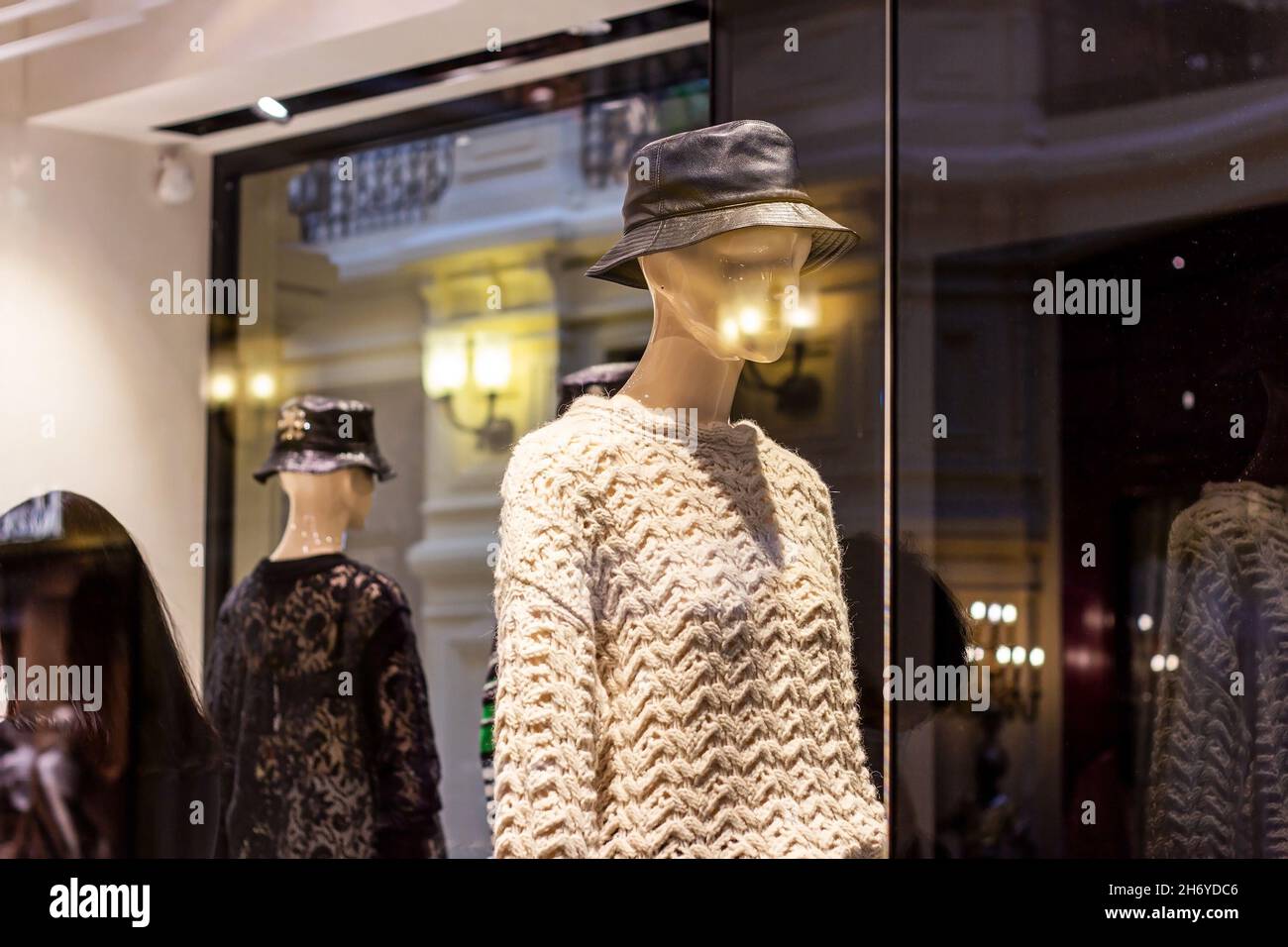 Fashionable women mannequins in trendy casual clothes on the clothing retail store window in the shopping mall. Stock Photo