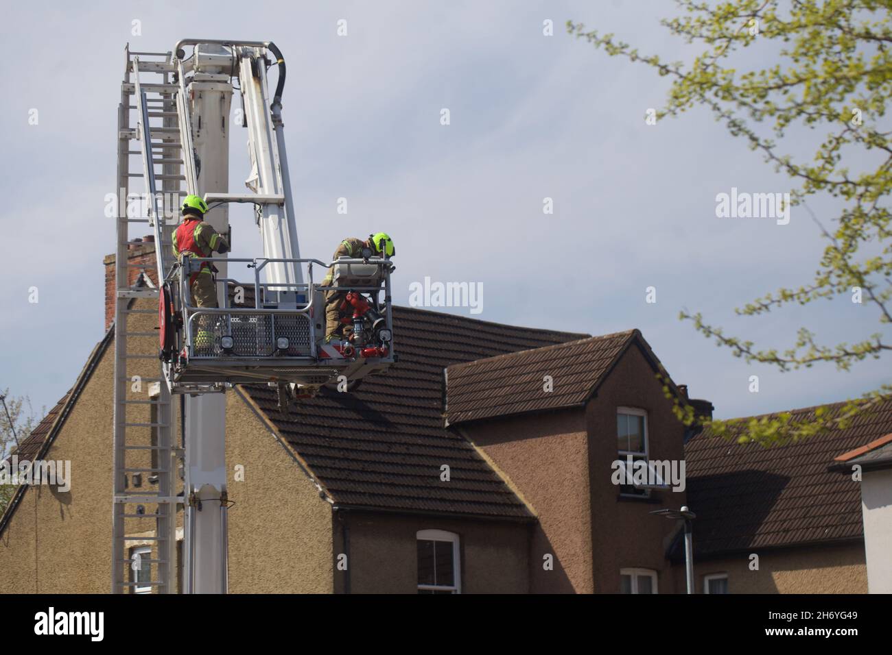 Firefighters on ladder Stock Photo