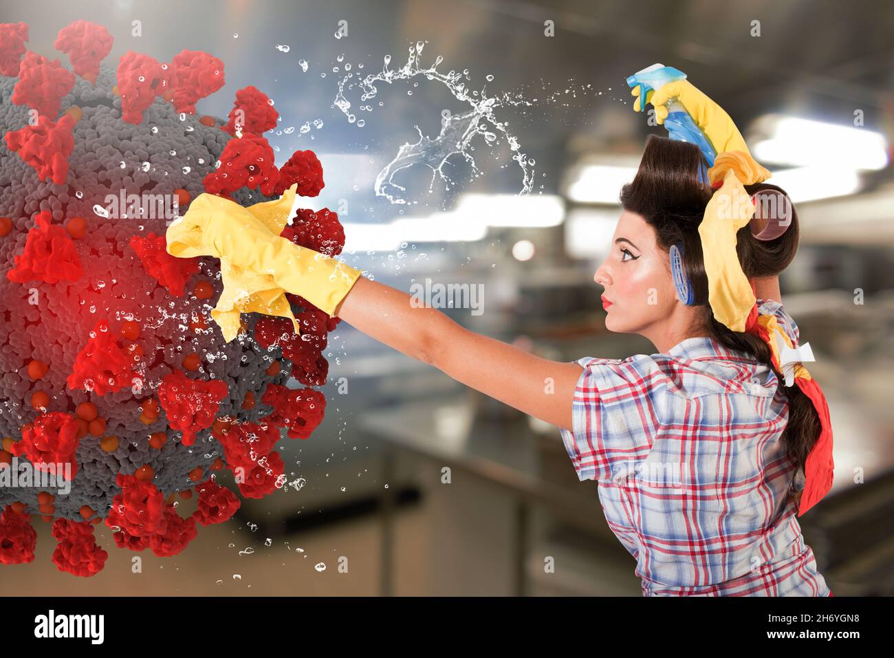 Funny housewife cleans and disinfects to keep covid-19 away Stock Photo