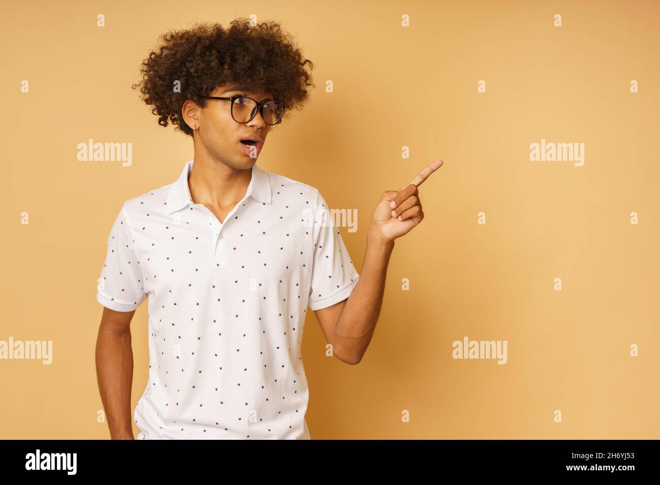 Amazed man with glasses indicates something with hand Stock Photo