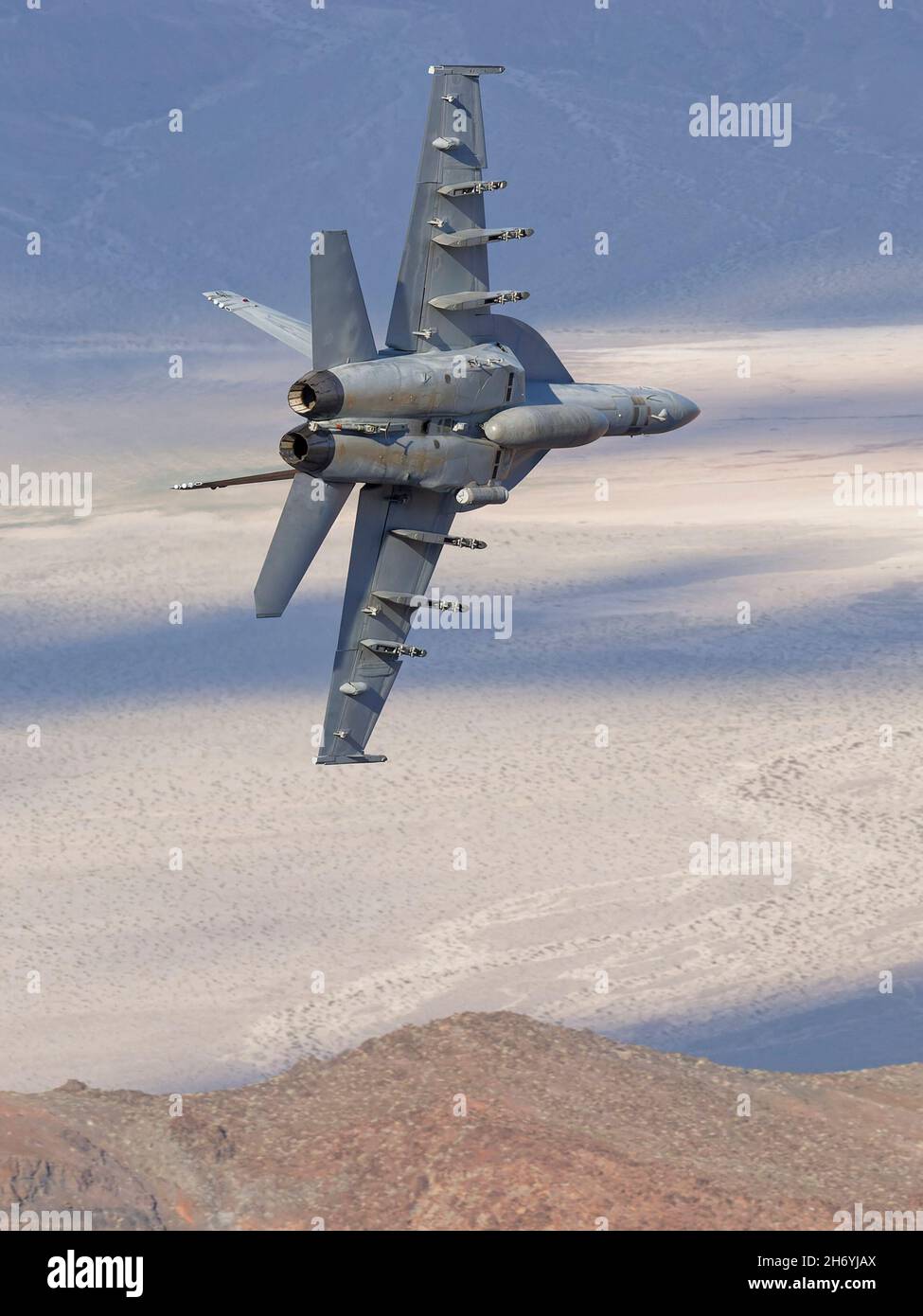 Boeing F/A-18E Hornet flown by US Navy squadron VFA-25 'Fist of the Fleet' from NAS Lemore Flying through Death Valley during 2019 Stock Photo