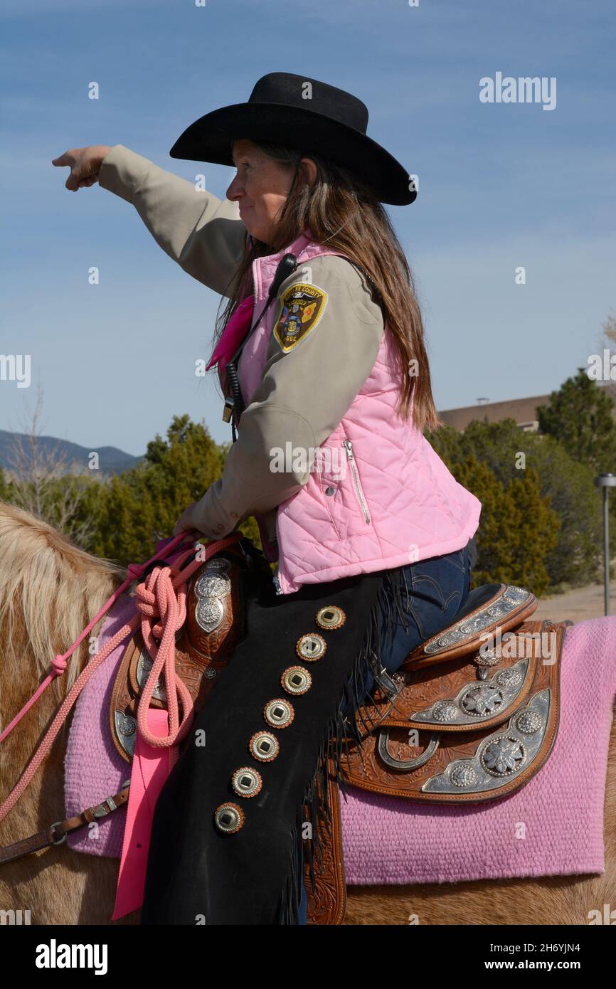 A member of the Santa Fe Sheriff's Posse, volunteers who conduct mounted (horseback) search and rescue missions, greet the public in Santa Fe, NM. Stock Photo