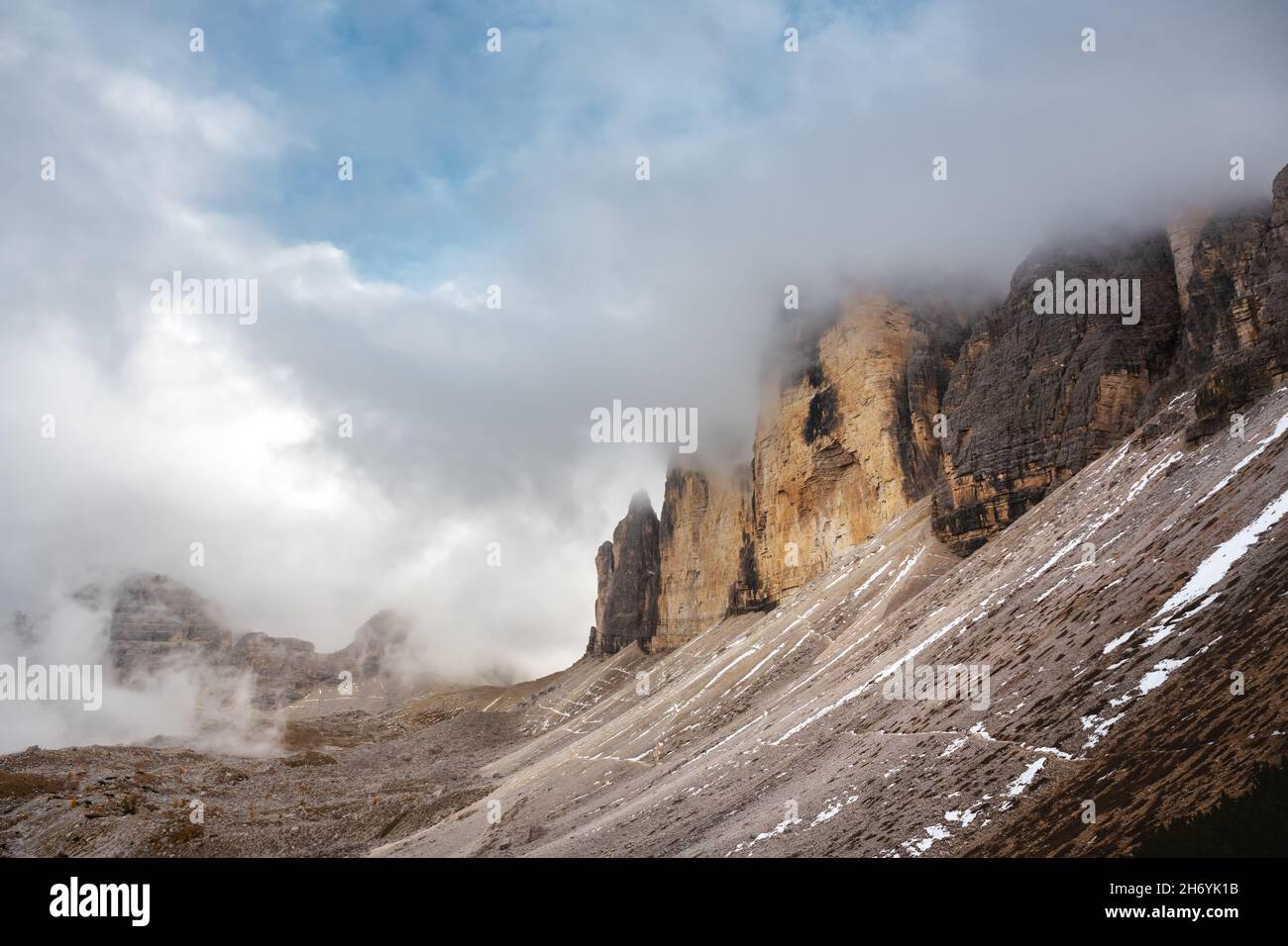 Incredible view of the Three Peaks of Lavaredo in morning fog. National Park Tre Cime di Lavaredo, Dolomite Alps mountains, Trentino Alto Adige region, Sudtirol, Dolomites, Italy Stock Photo