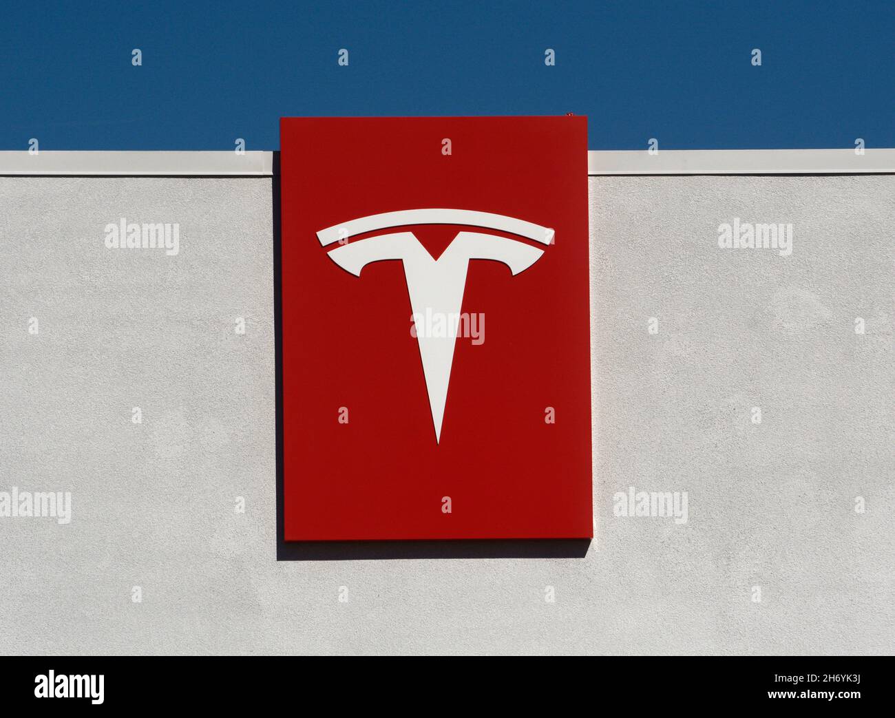 Tesla logo and signage on the exterior of a Tesla dealership and service garage in Santa Fe, New Mexico. Stock Photo