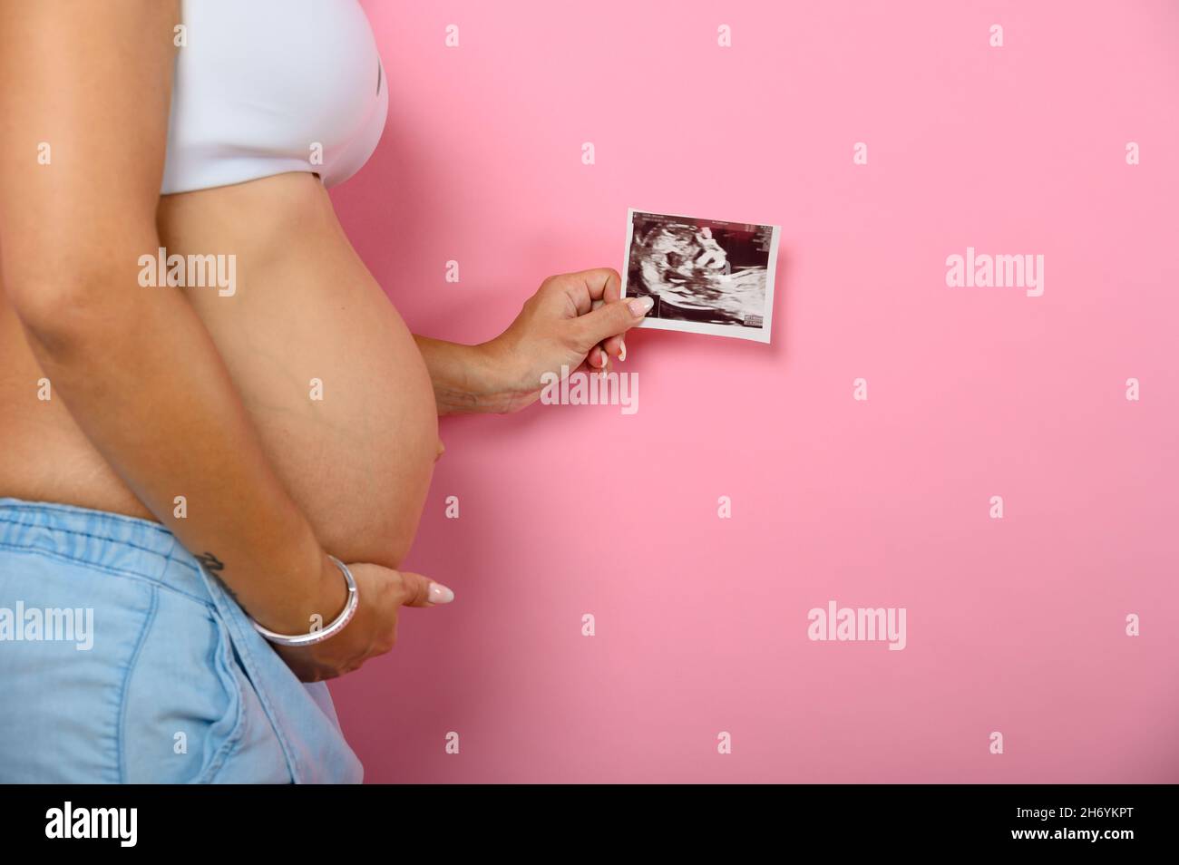 Pregnant mom shows an ultrasound of her son Stock Photo