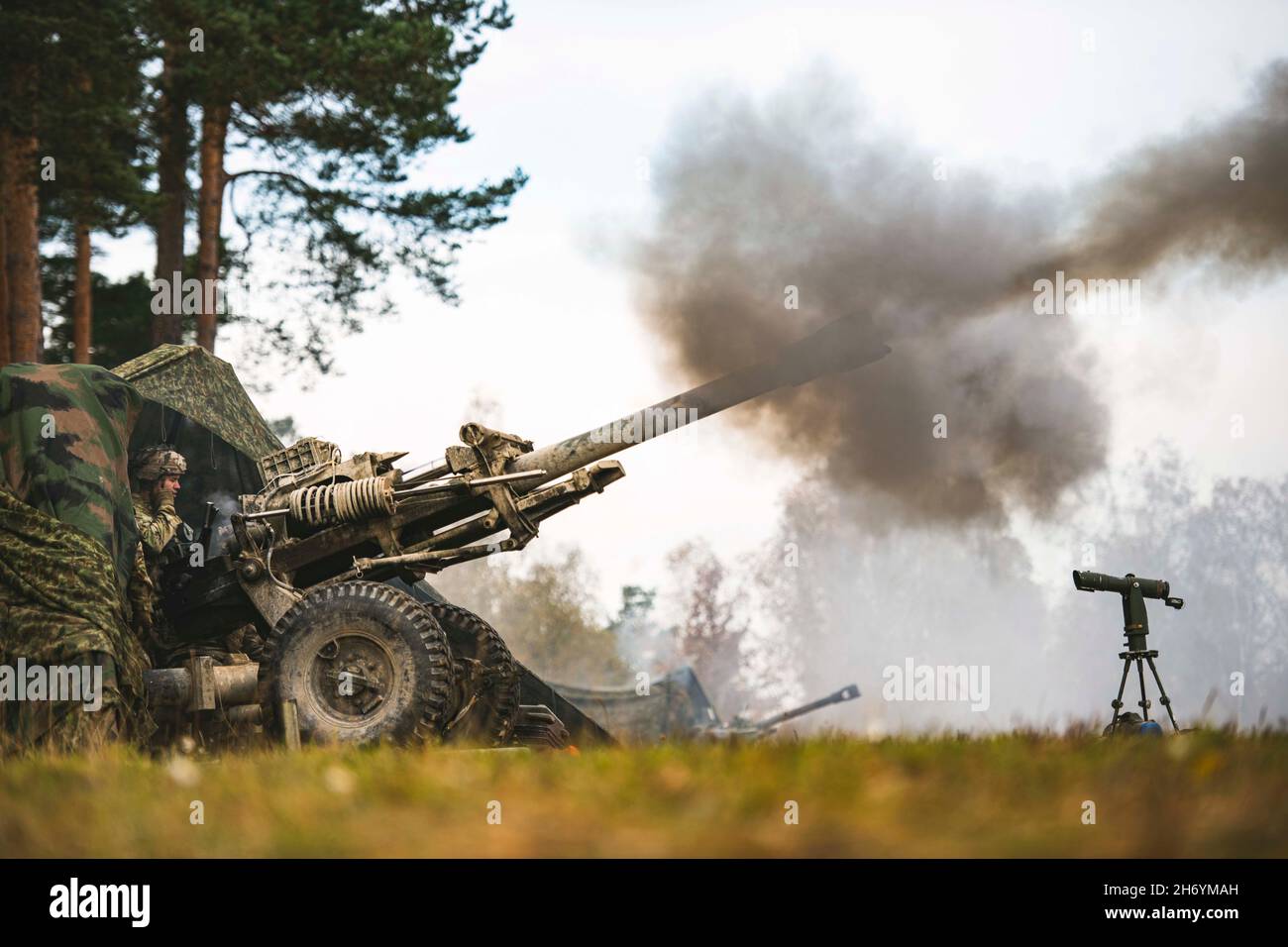 Grafenwoehr, Germany. 25th Oct, 2021. U.S. Army paratroopers assigned to 4th Battalion, 319th Airborne Field Artillery Regiment fire a M119A3 Howitzer during a field artillery live fire exercise. This training is part of Exercise Bayonet Ready 22 at the Joint Multinational Training Center in the Grafenwoehr Training Area, Germany from Oct. 25, 2021. Exercise Bayonet Ready 22 is a directive of the USA Army Southern European Task Force Africa being conducted by 7th Army Training Command and the 173rd Airborne Brigade at the Joint Multinational Readiness Center in the Hohenfels Training Area, Stock Photo