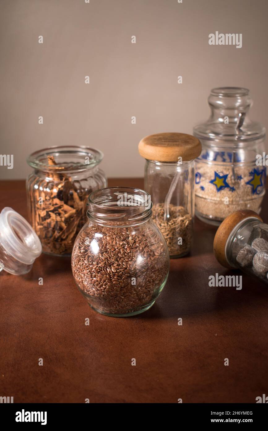 Different spices in some glass bottles on a table Stock Photo