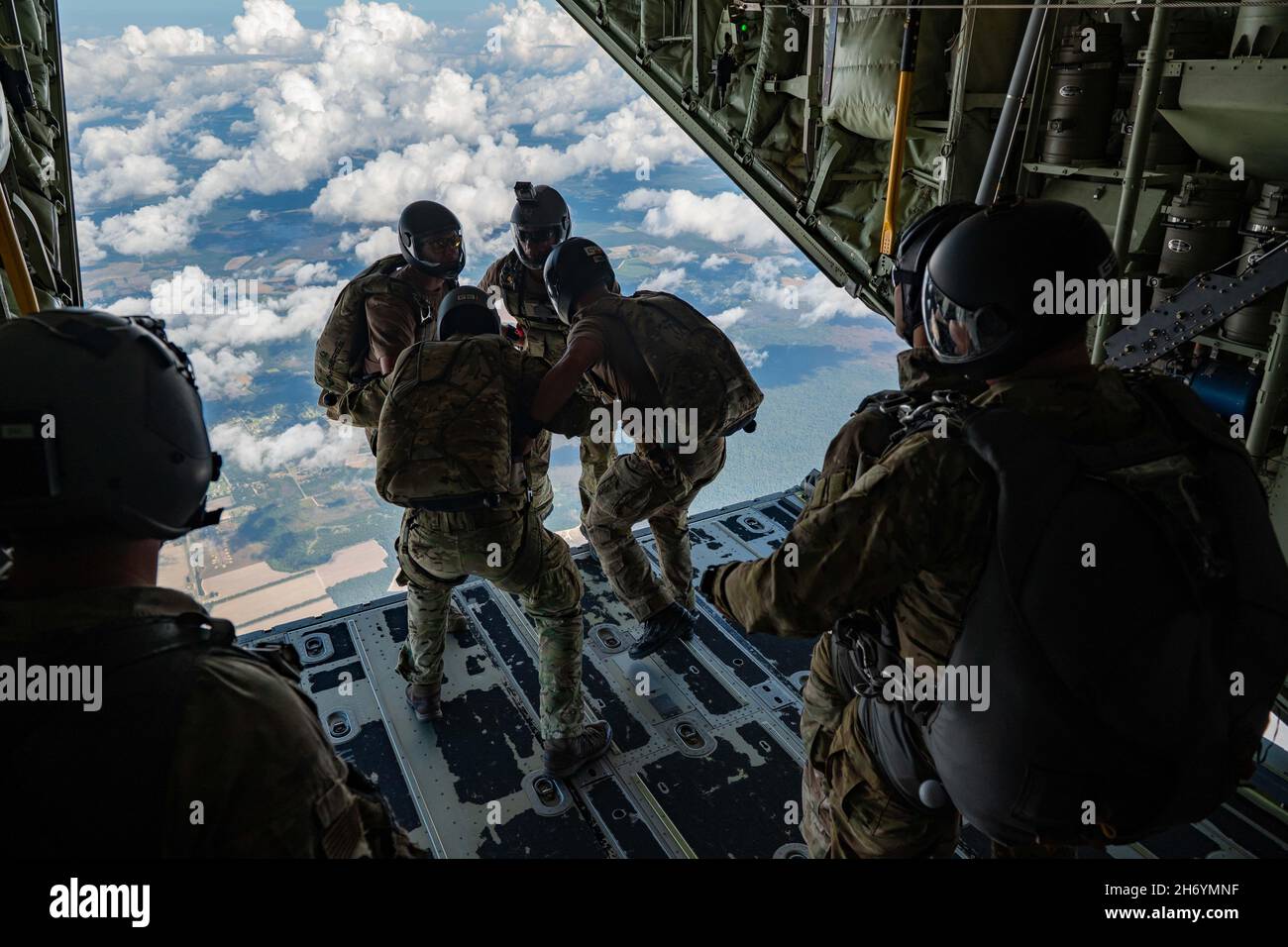 Moody Air Force Base, Georgia, USA. 22nd Oct, 2021. U.S. Air Force pararescuemen assigned to the 38th Rescue Squadron prepare to jump in a linked formation from a HC-130J Combat King II near Moody Air Force Base, Georgia, Oct. 22, 2021. PJs are qualified to conduct both static-line and high-altitude, low-opening jumps. The mission of the 38th RQS is to employ combat ready rescue officers and pararescuemen to support units worldwide. Credit: U.S. Air Force/ZUMA Press Wire Service/ZUMAPRESS.com/Alamy Live News Stock Photo