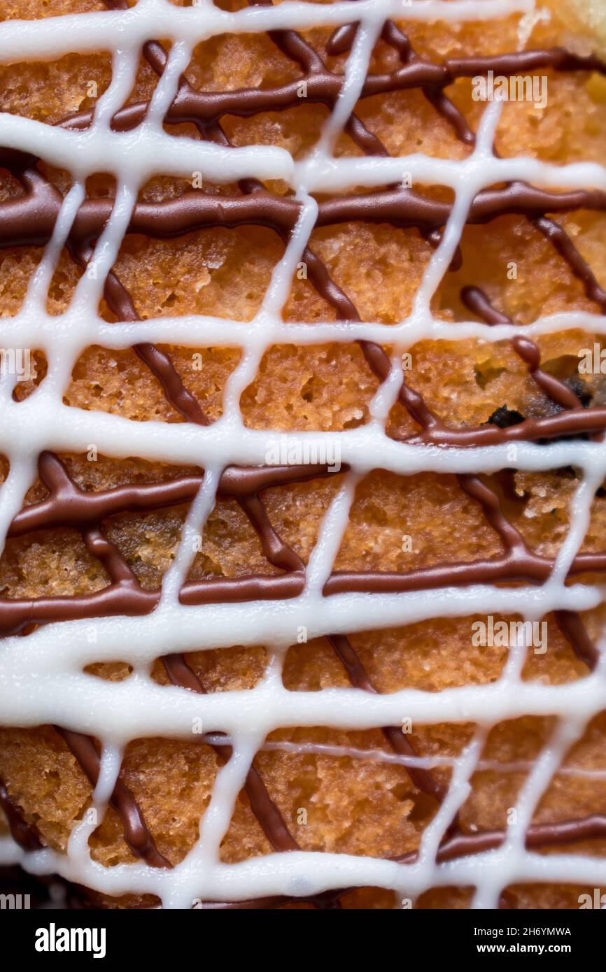 Close up of a chocolate cake texture with white and brown lines of cream Stock Photo
