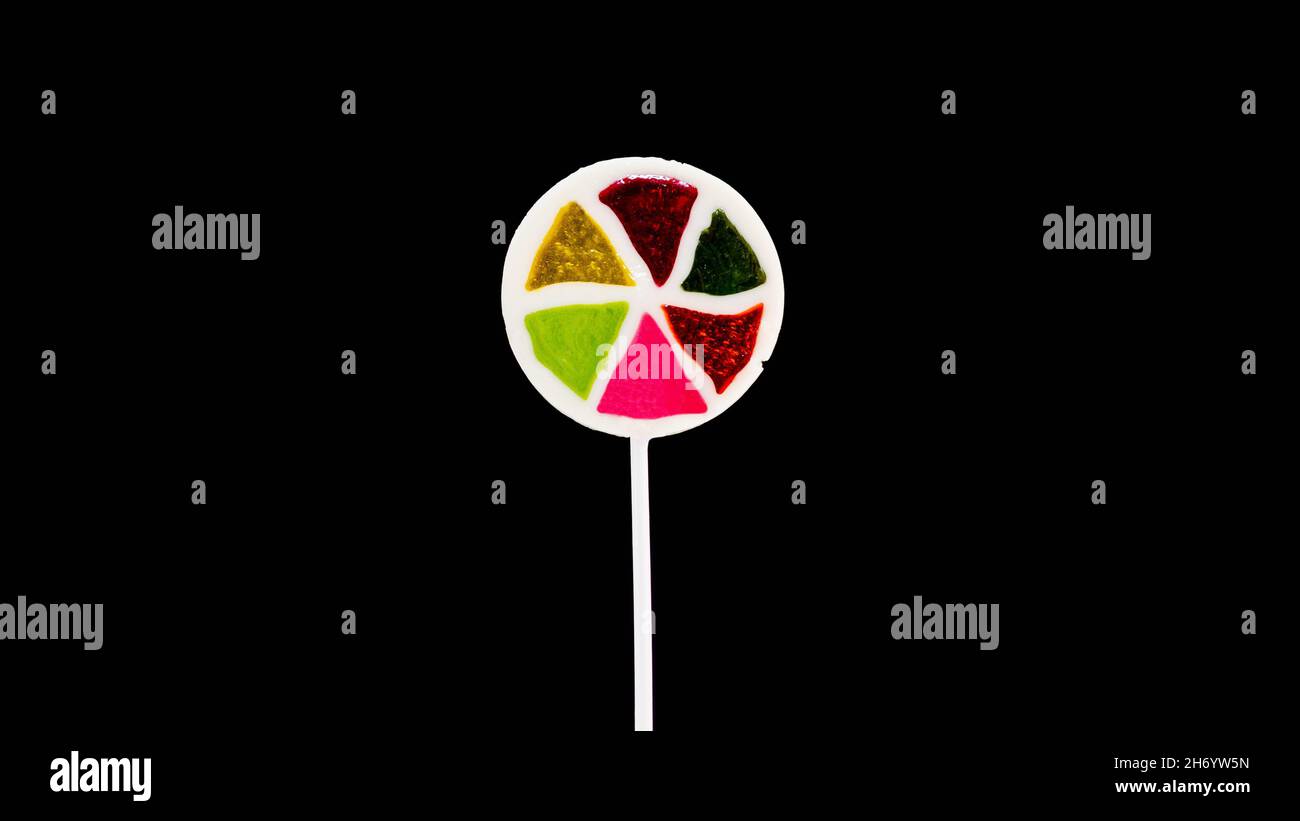 Lollipop on a black background copy space. Multi-colored candy. Stock Photo