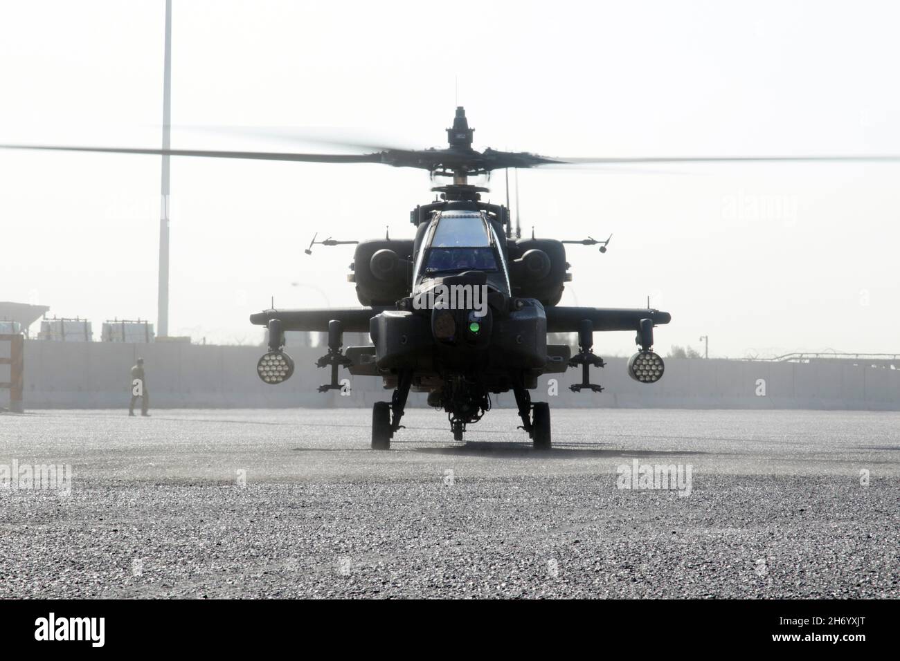 An AH-64E Apache helicopter assigned to the Fort Bragg, North Carolina, based 82nd Combat Aviation Brigade, 82nd Airborne Division, lands at the Port of Shuaiba, Kuwait, Nov. 10, 2021, in preparation for retrograde operations. The Aberdeen Proving Ground, Maryland, based 1100th Theater Aviation Sustainment Maintenance Group oversaw the preparations for the retrograde of more than 30 aircraft assigned to the 82nd CAB from Nov. 7-12. The Soldiers and aircraft were deployed to Afghanistan to support base closures and the U.S. military’s exit from the Hamid Karzai International Airport in Kabul. Stock Photo