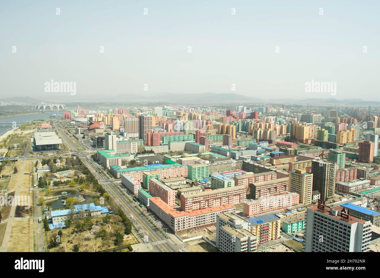 The view of colourful apartment blocks of central Pyongyang and the Taedong River seen from the top of the Juche Tower in North Korea. Stock Photo