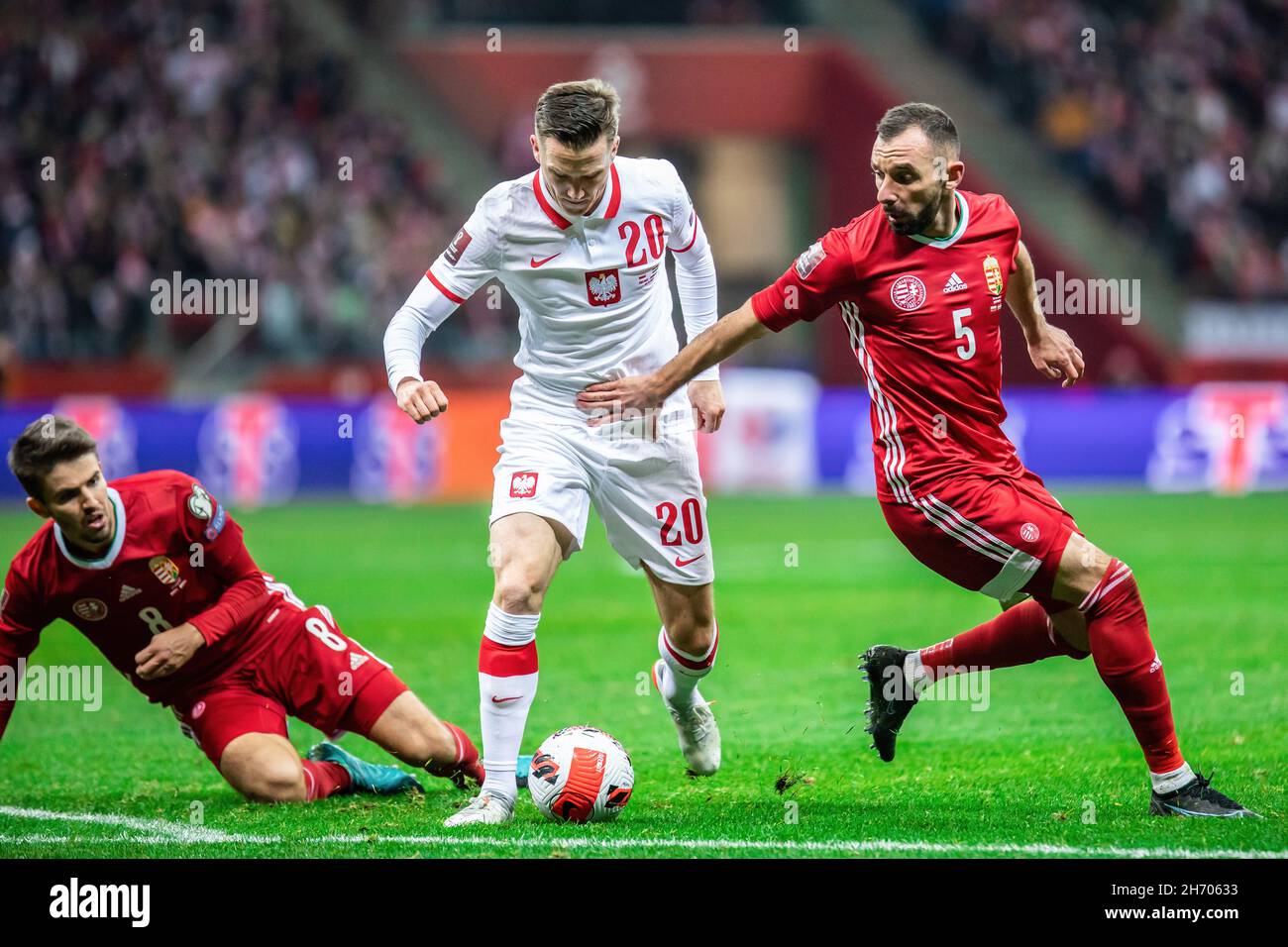Warsaw, Poland. 15th Nov, 2021. Adam Nagy (L) of Hungary, Piotr Zielinski (C) of Poland, and Attila Fiola (R) of Hungary are seen in action during the FIFA World Cup 2022 Qatar qualifying match between Poland and Hungary at PGE Narodowy Stadium. Final score; Poland 1:2 Hungary. (Photo by Mikolaj Barbanell/SOPA Images/Sipa USA) Credit: Sipa USA/Alamy Live News Stock Photo