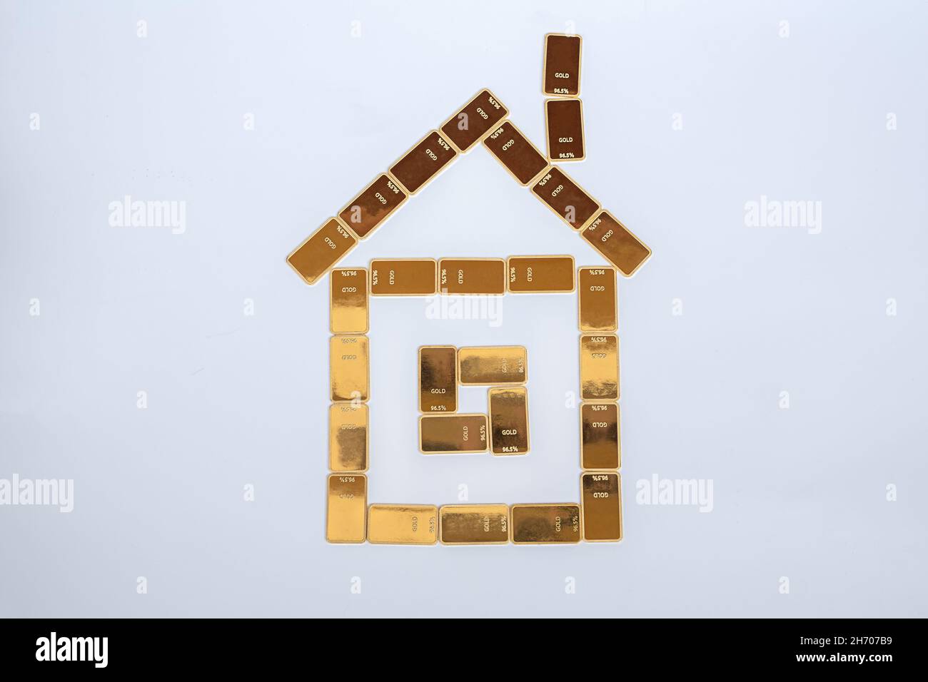 House of gold bars. Stability concept. Gold bar building on a white background Stock Photo