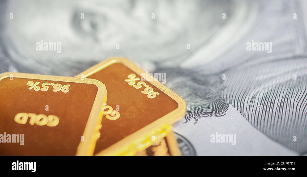 Gold bars on the background of banknotes. Gold with money Stock Photo