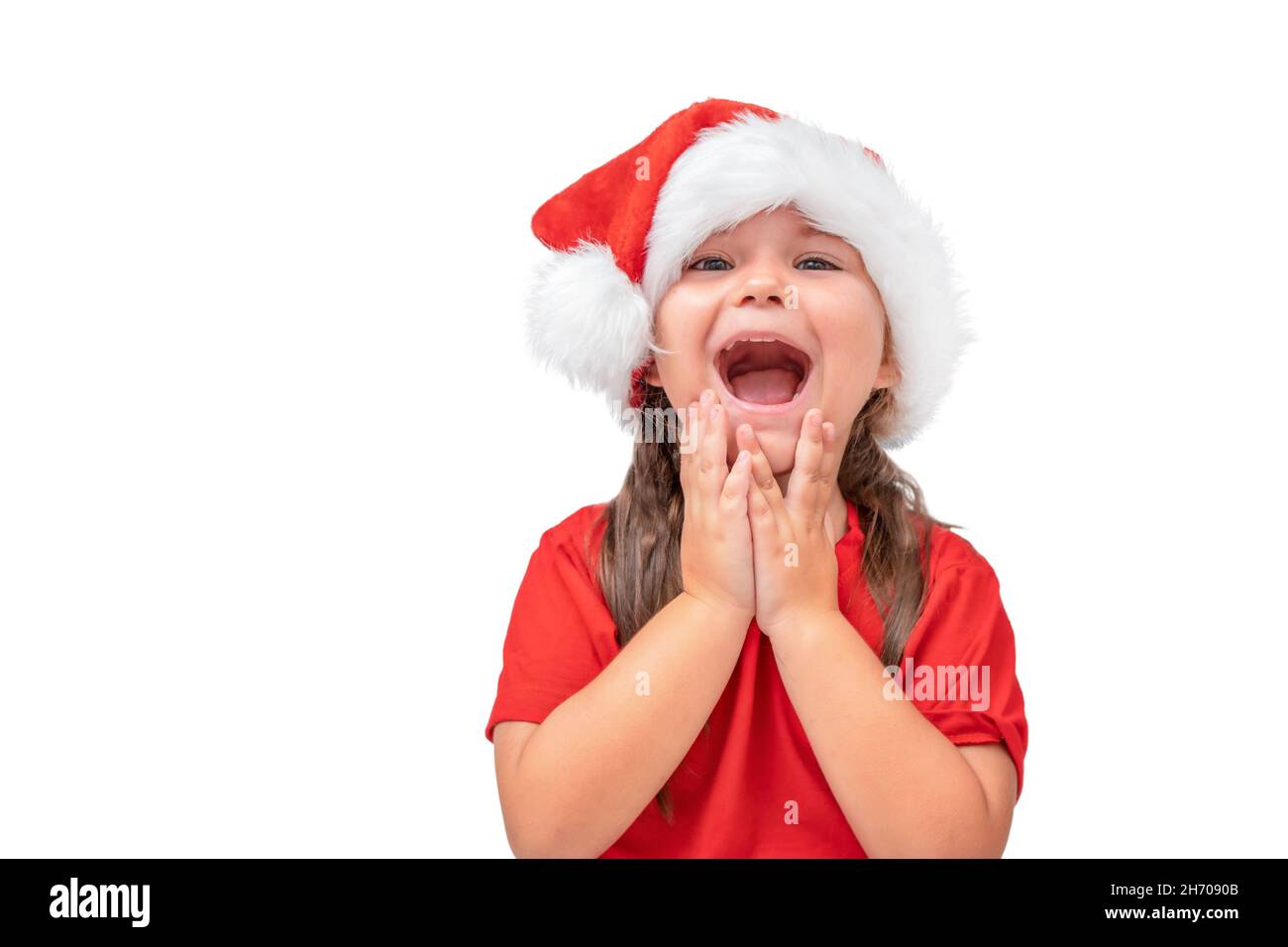 Christmas portrait of surprised child in santa hat isolated on white background Stock Photo