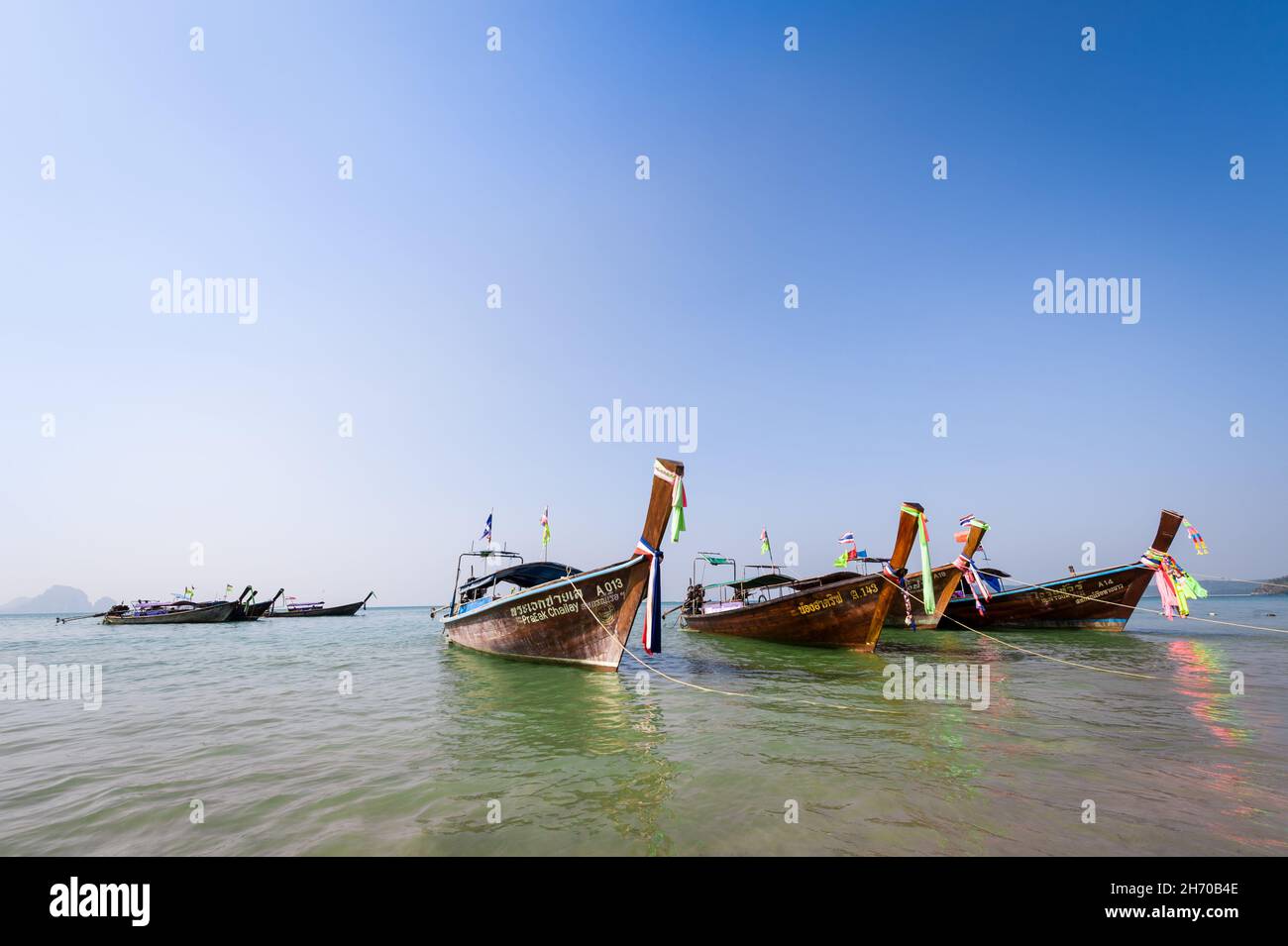 Krabi, Thailand, 29 Jan 2015: Traditional wooden long tail boats anchored at sea at Krabi. Resort, travel and vacation concepts. Stock Photo