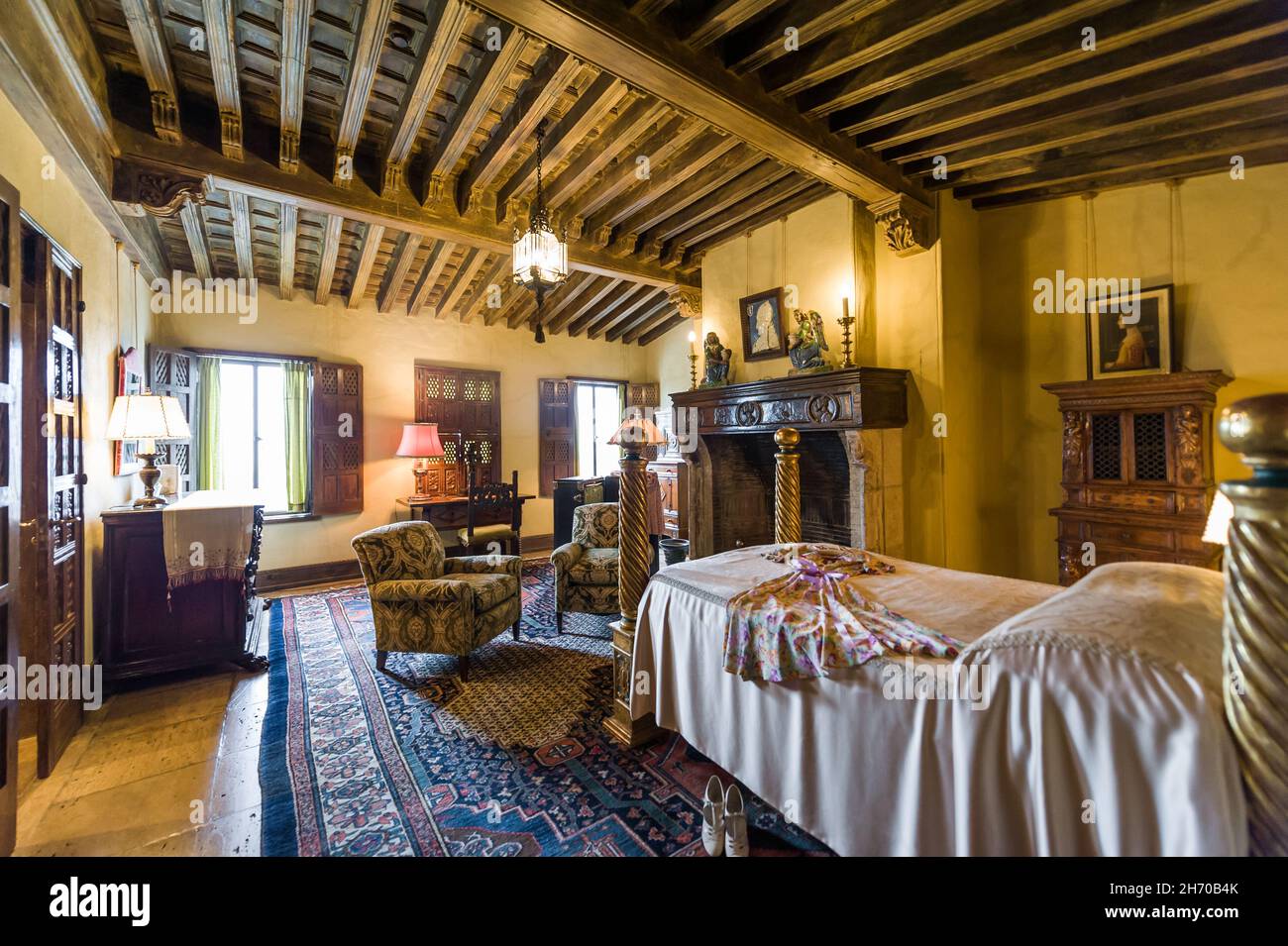 California, USA, 09 Jun 2013: Bedroom with intricate carvings and fireplace at Hearst Castle, which is a National and California Historical Landmark o Stock Photo