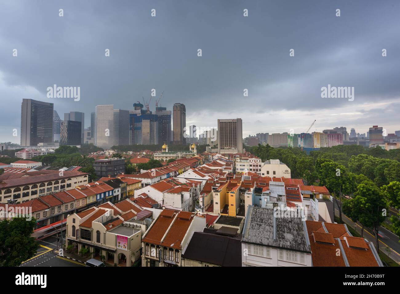 Singapore, 31 Dec 2015: Stormy weather over city skyline and historical landmarks. Stock Photo