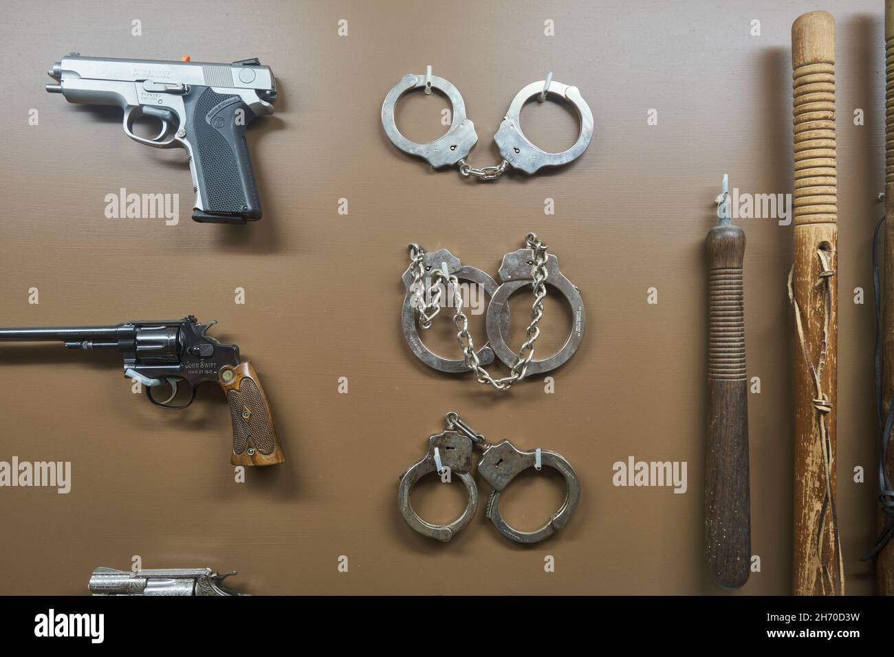 Various old handcuffs, batons, guns used by the local police department for law enforcement. At the Lyman and Merrie Wood Museum of Springfield Histor Stock Photo