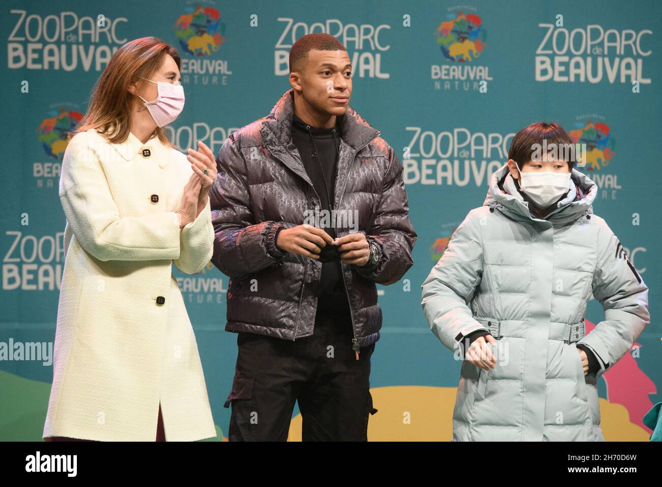 French footballer and PSG star Kylian Mbappe and China's gold medalist in  10-meter synchronised diving at the Tokyo Olympics, Zhang Jiaqi attending a  ceremony at Beauval zoo, center France on November 18,