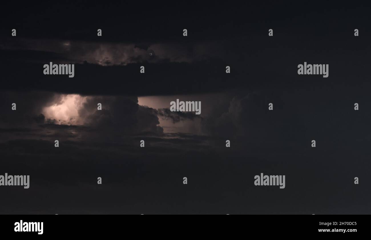 Lightning storm at night over city Stock Photo - Alamy