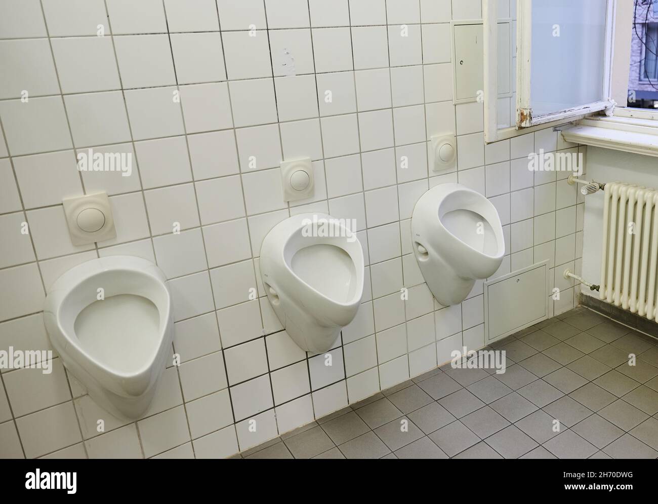 Berlin, Germany. 18th Nov, 2021. Three urinals hang in a school toilet of a high school in