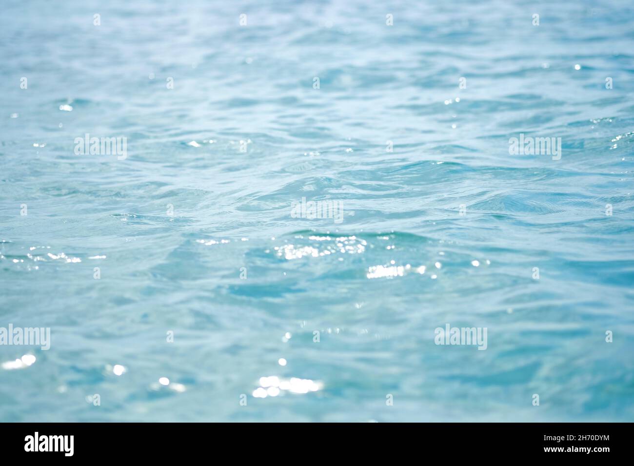 Close-up of blue water in the sea or ocean. Side view. Copy space.Empty showcase,packaging product presentation.Background for cosmetic products. Stock Photo