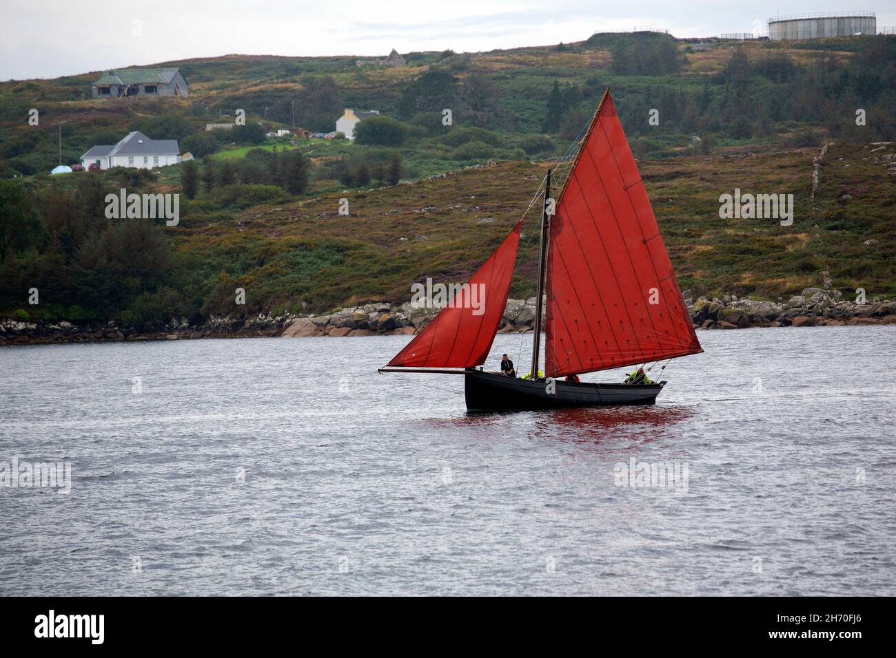 A Galway hooker in the waters off Connemara with its distinctive red saiils. Stock Photo