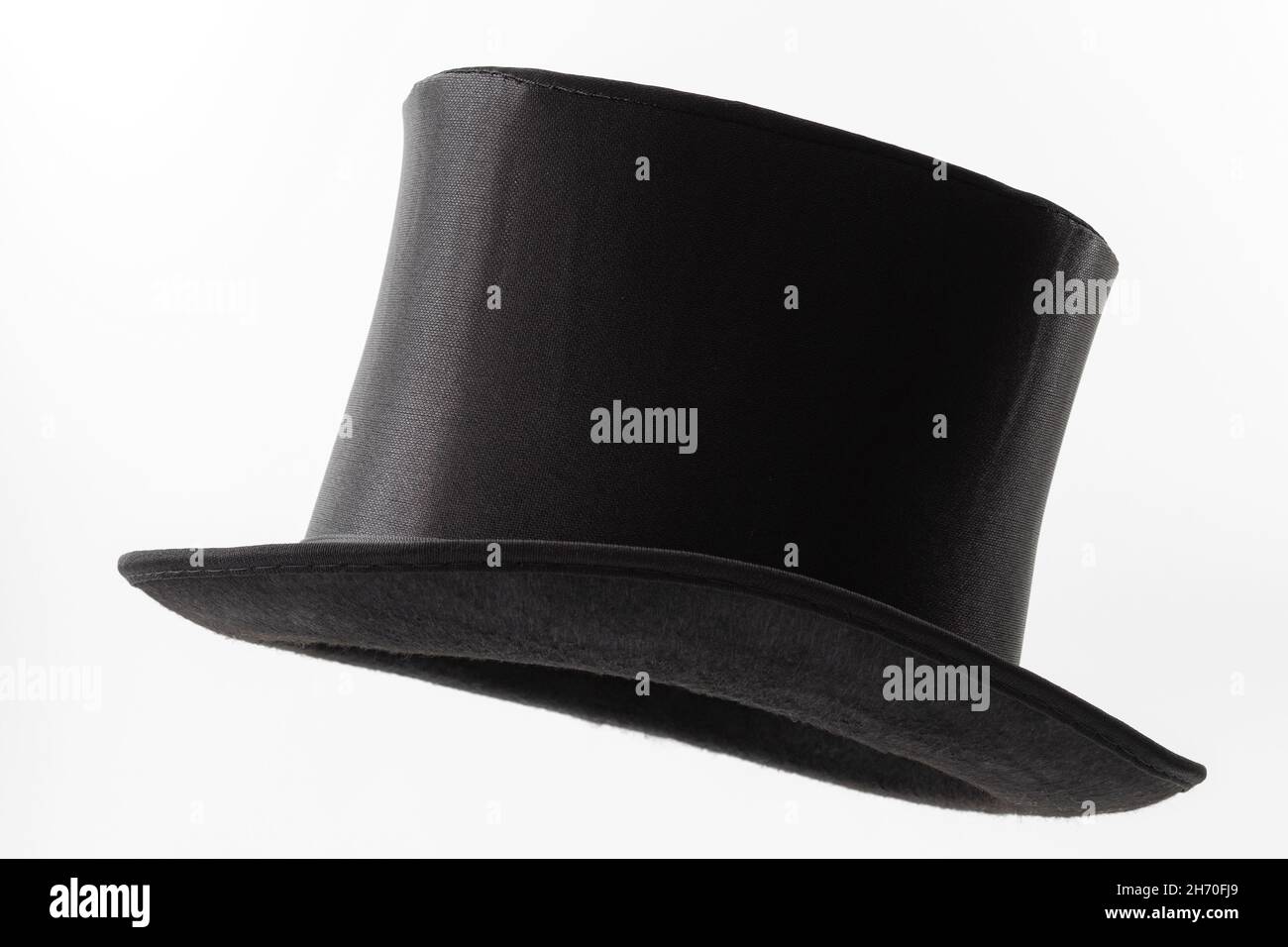Vintage men fashion and magic show conceptual idea with side profile angle on victorian black top hat with clipping path cutout in ghost mannequin tec Stock Photo