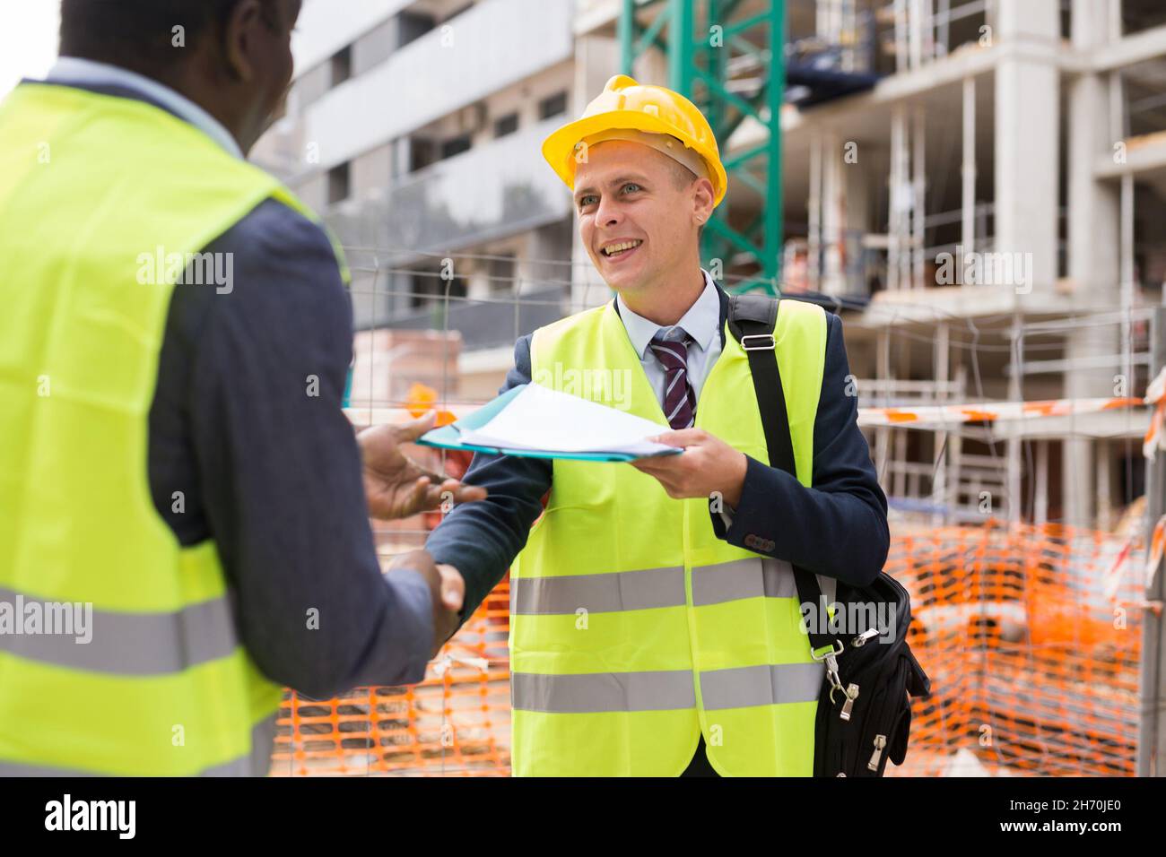 Architect and engineer construction workers shaking hands while working for teamwork  Stock Photo